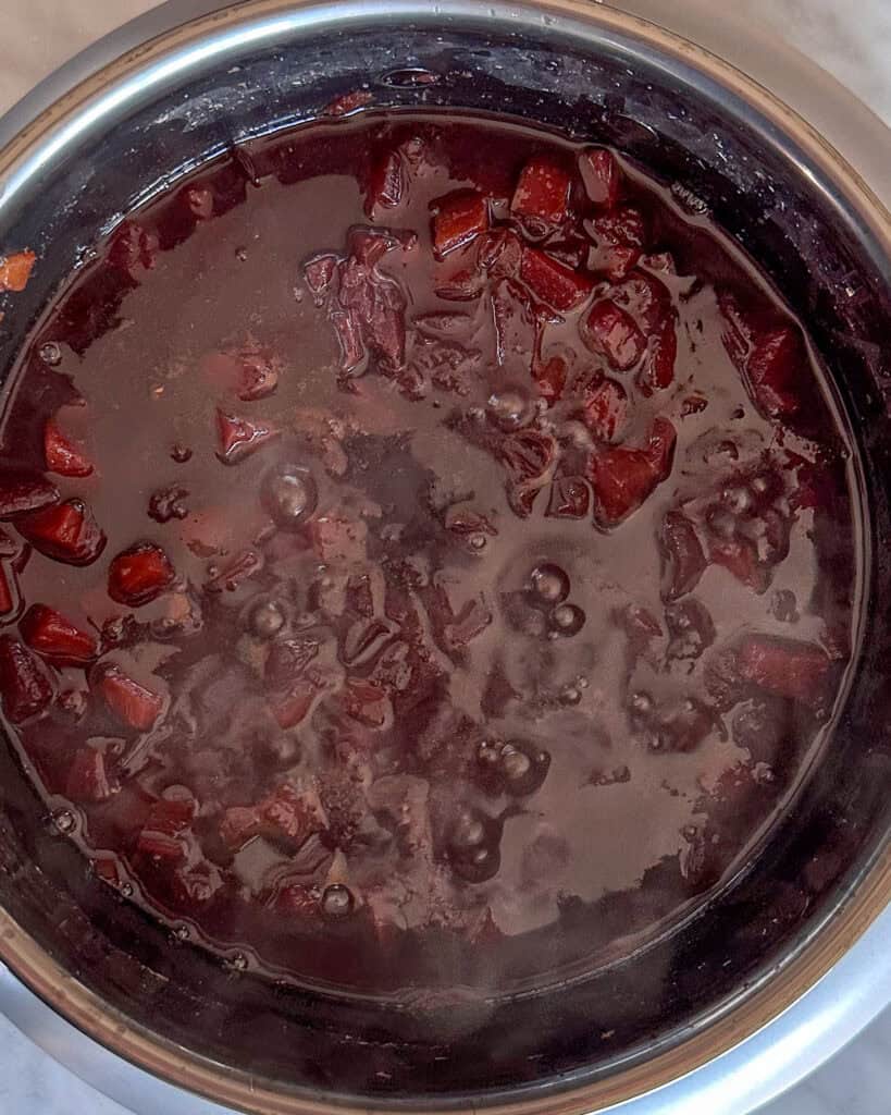 Cook the plums until they have completely broken down to create a sticky jam consistency.