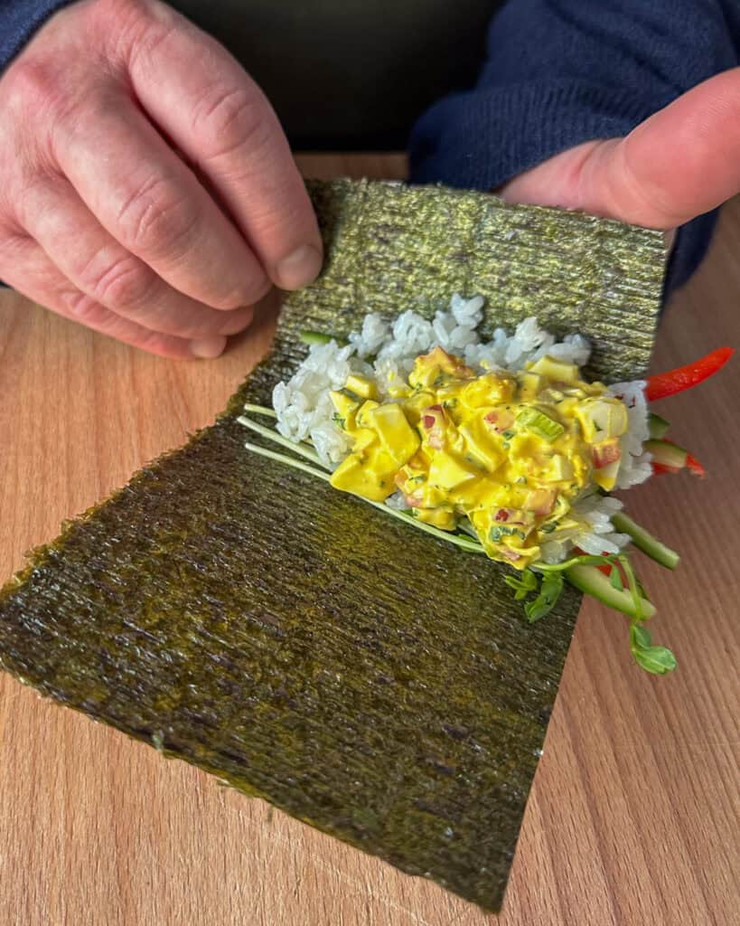 How to roll temaki - Roll the seaweed into a cone shape.