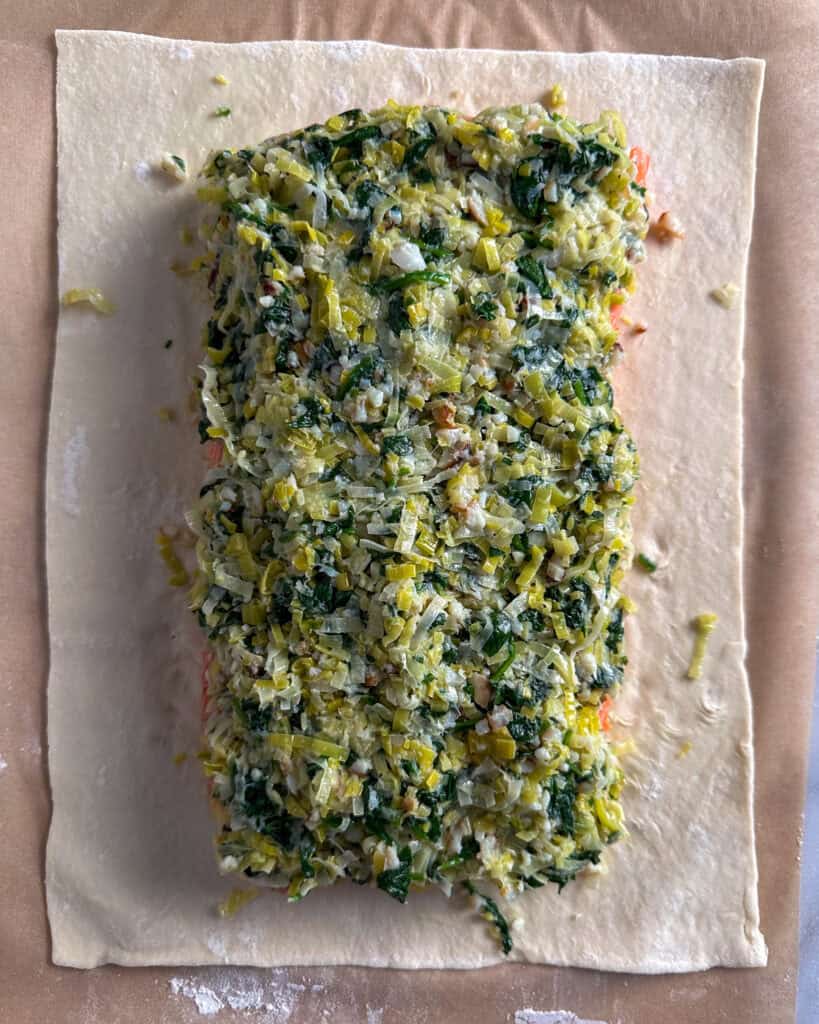 Leek filling spooned evenly over the salmon.