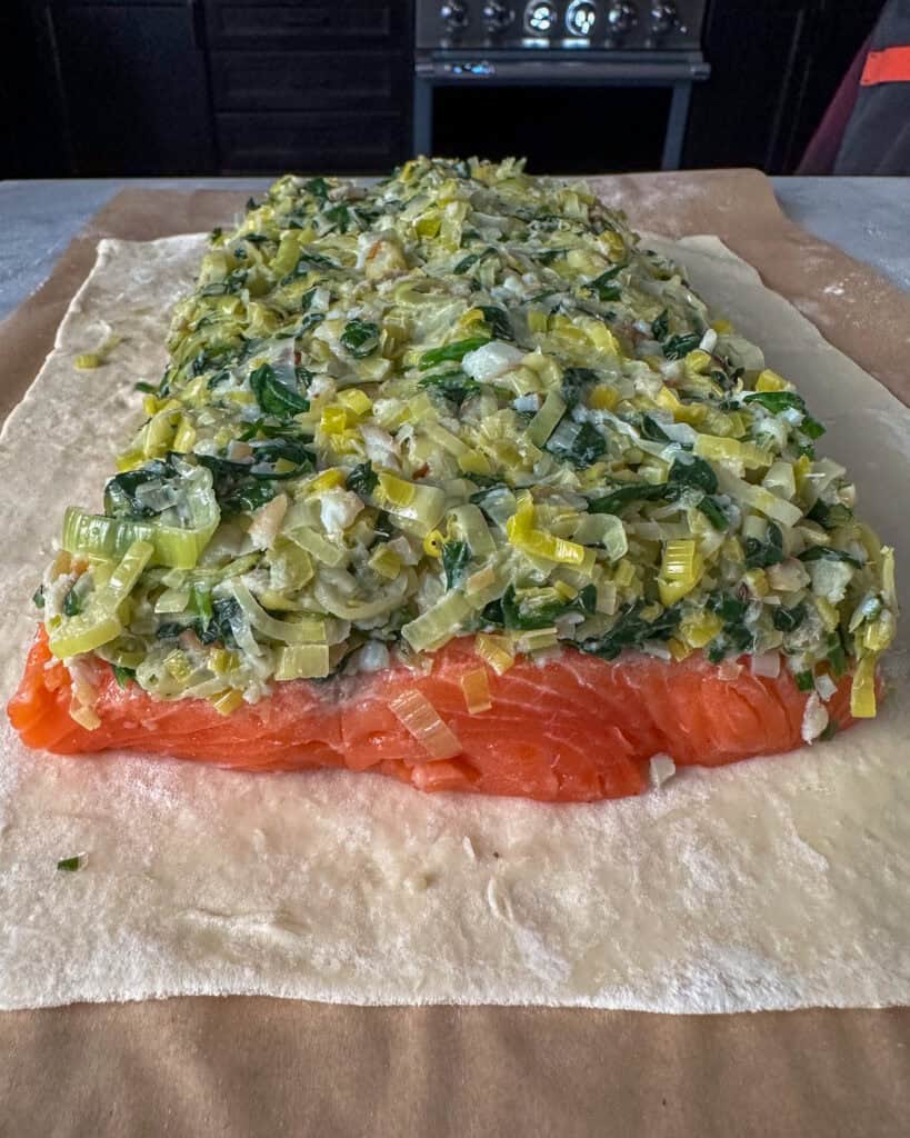 Side view of the leeks on the salmon en croûte.