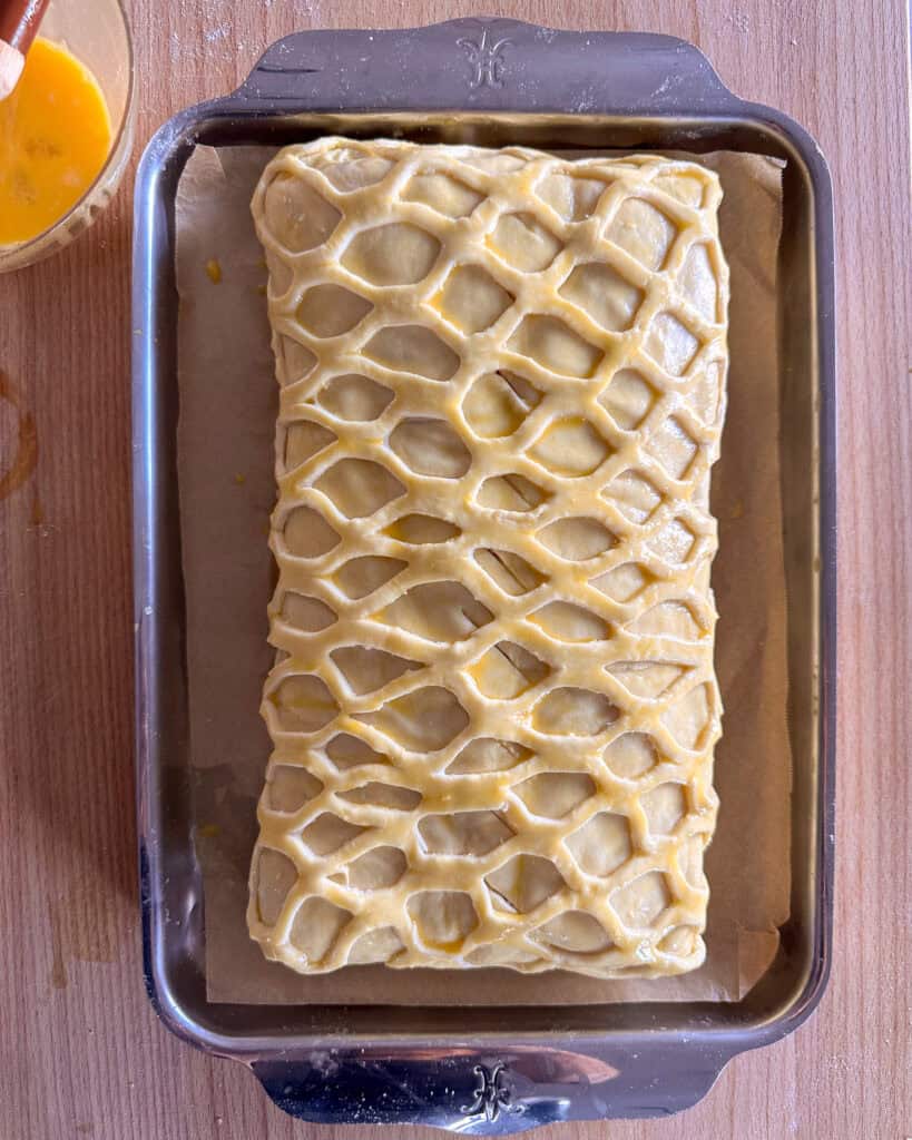Apply the egg wash over the entire salmon wellington.