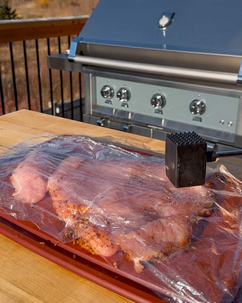 Place plastic wrap over the turkey and pound with a meat mallet until ½-inch thick and even.