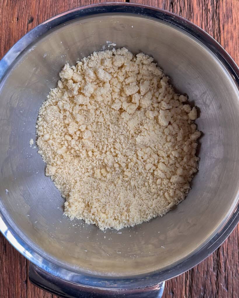 Work the butter into the flour using your fingers until the mixture resembles coarse crumbs.