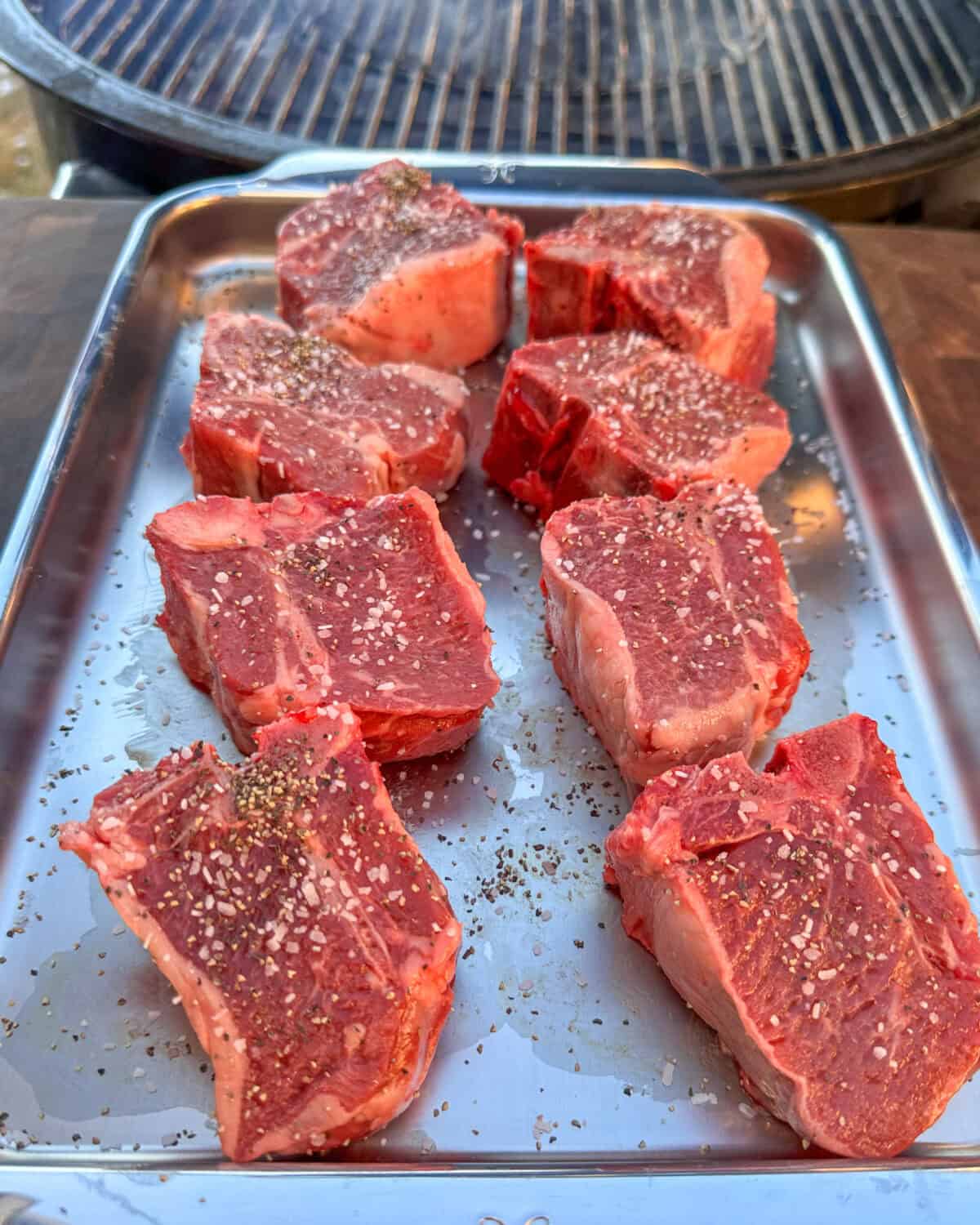 Thick cut lamb chops seasoned with salt and pepper.