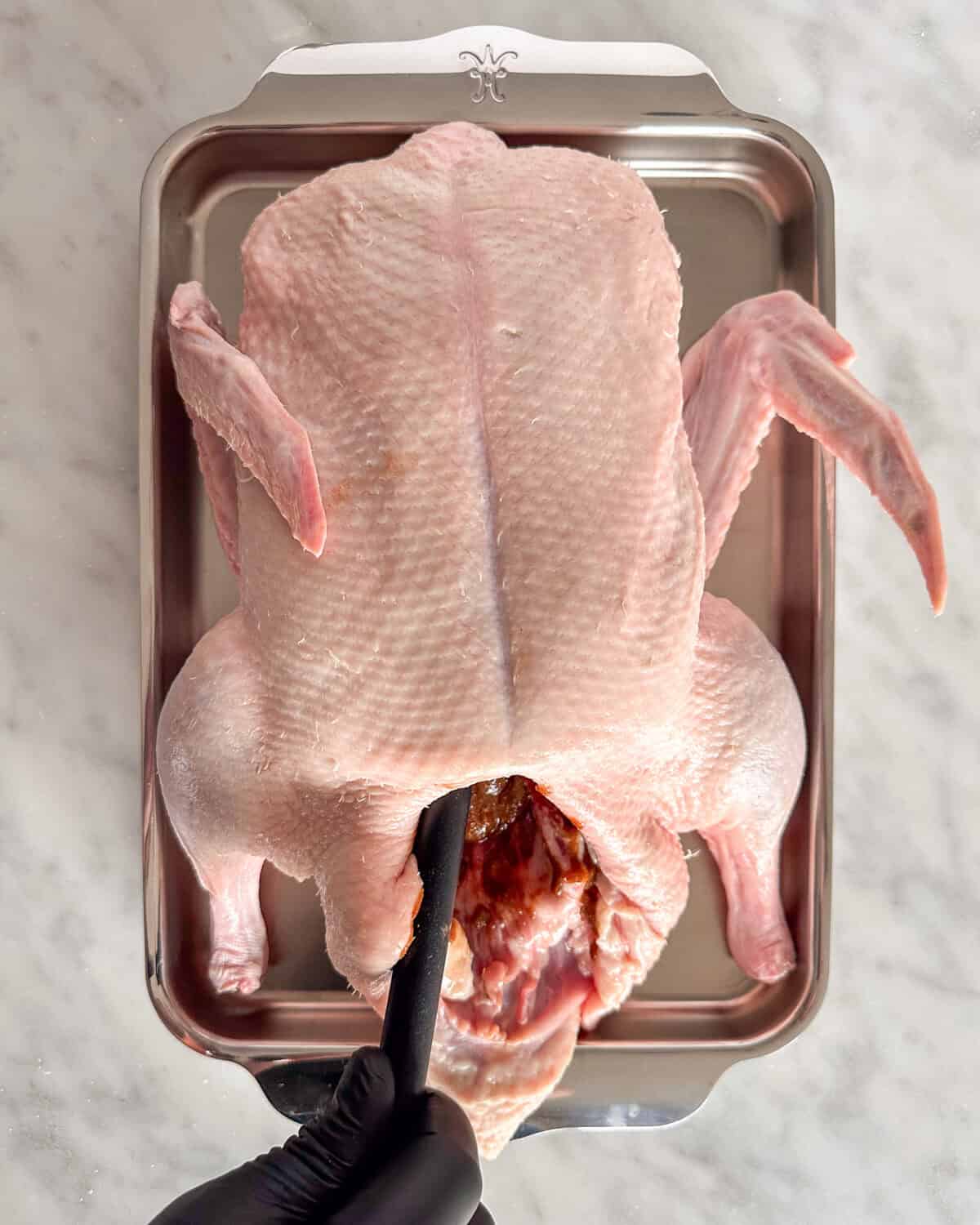 Rub the herb-hoisin mixture inside the duck cavity until well coated.