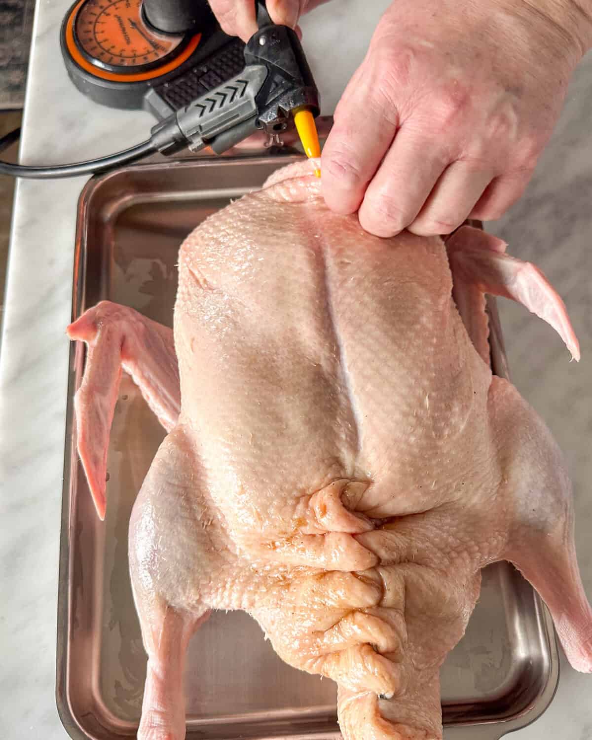 Use a bicycle pump with an inflator needle to carefully separate the duck skin from the meat.