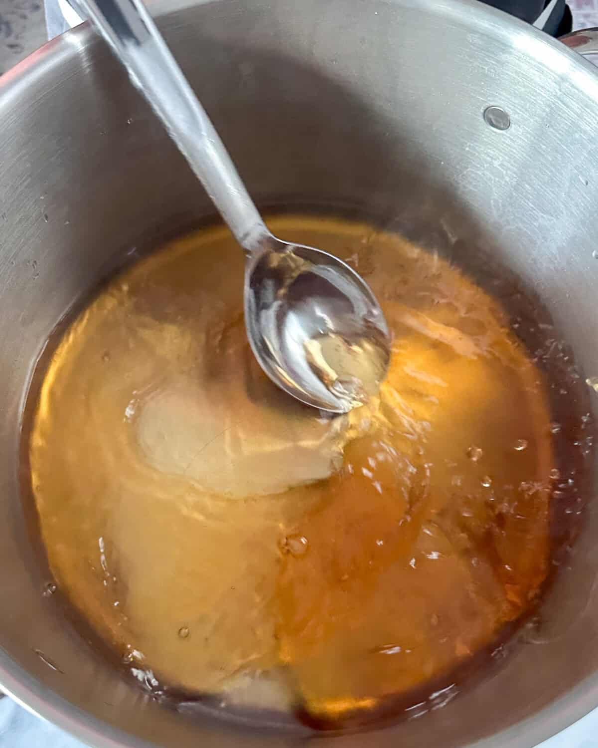 In a saucepan, combine water, red vinegar, and maltose. Heat until the maltose dissolves.