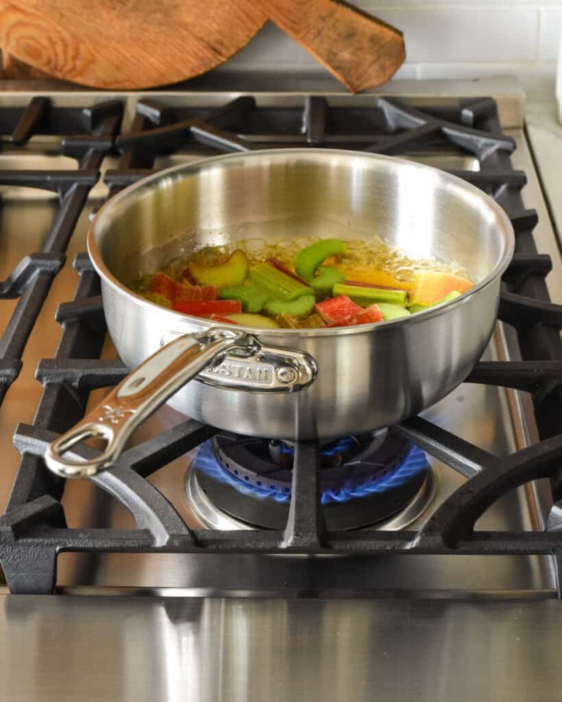 A 2-Quart Saucier on the range making a sauce