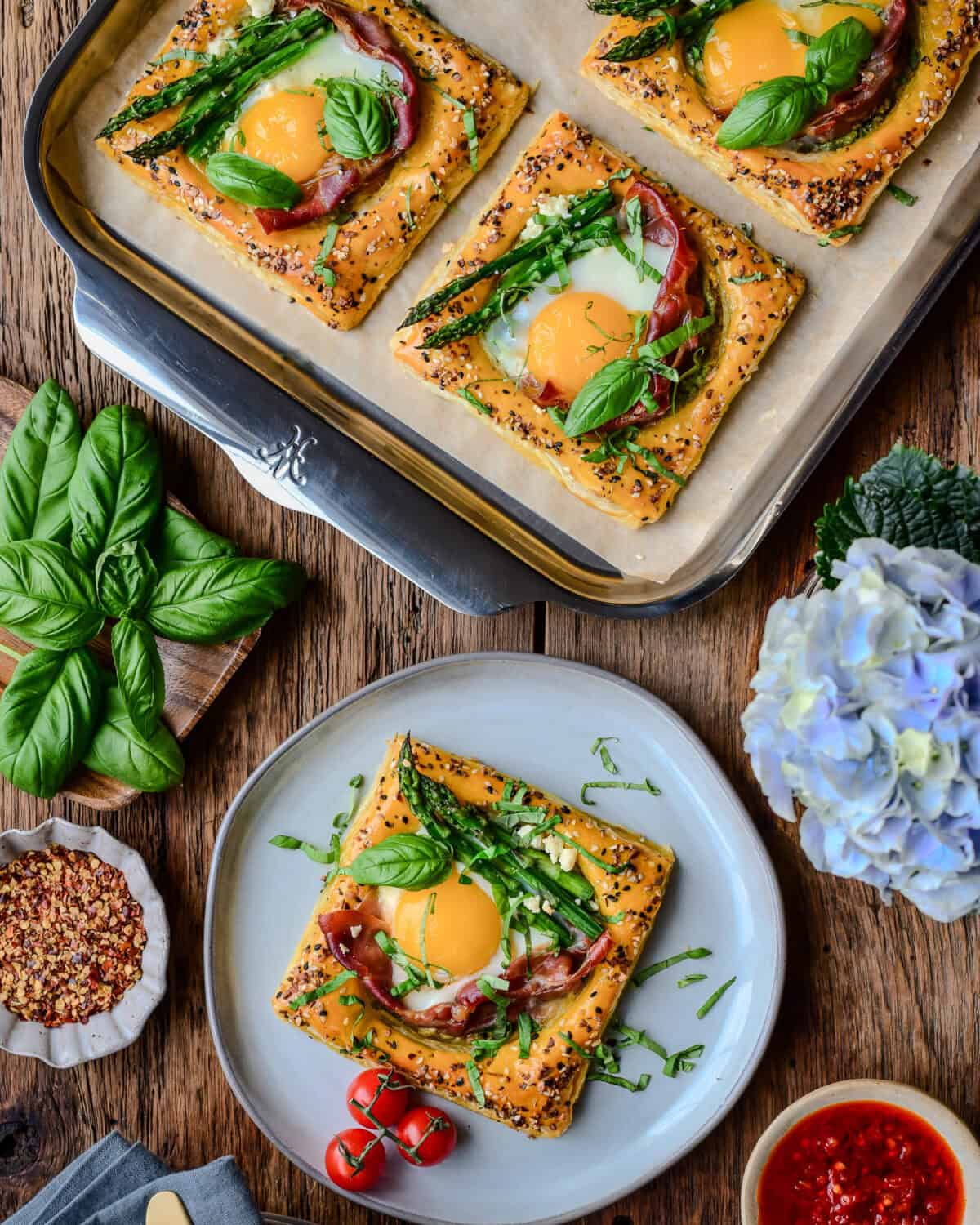 A sheet pan with puff pastry breakfast tart along with a plated tart.