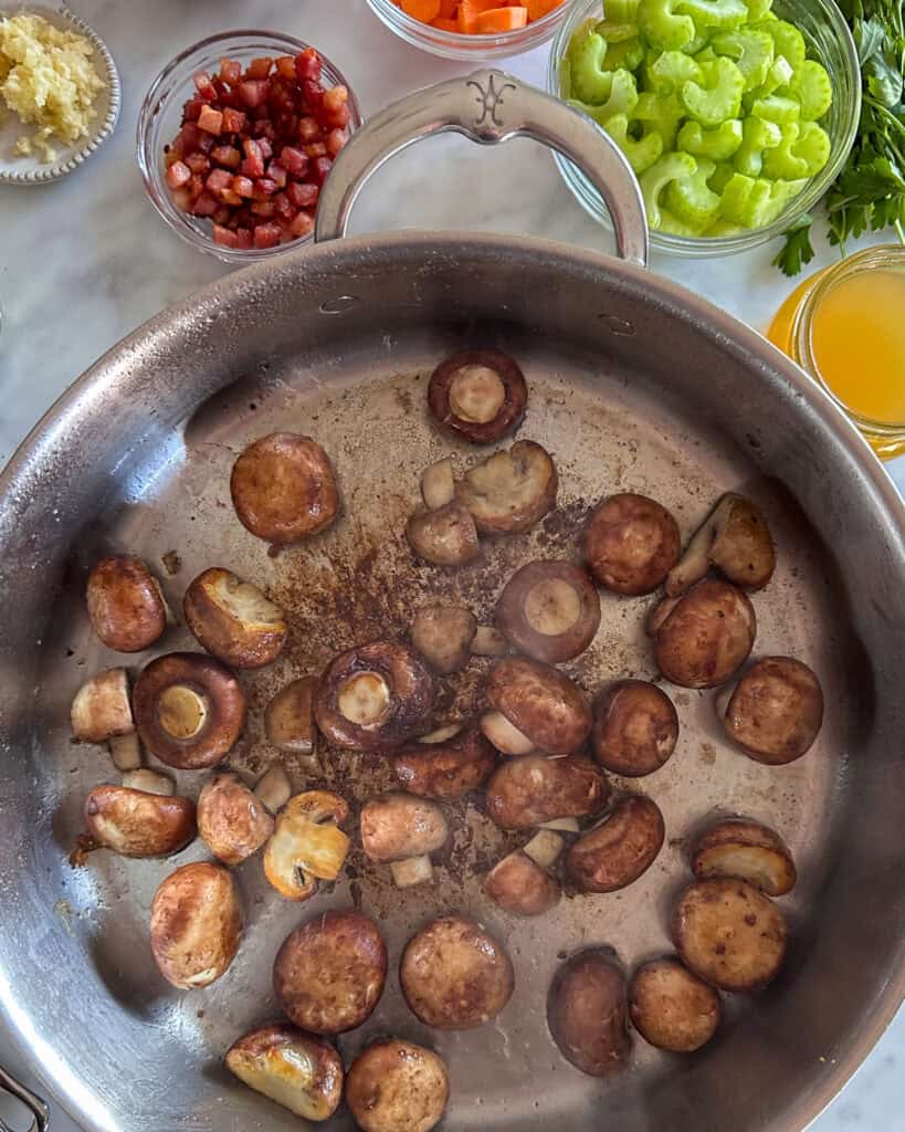 Sauté mushrooms in a pan.