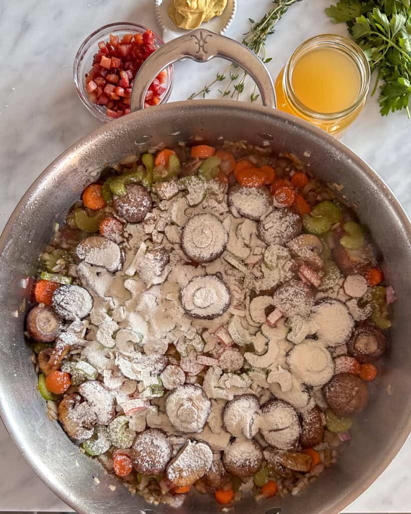 Sprinkle flour over the vegetables using a sieve.