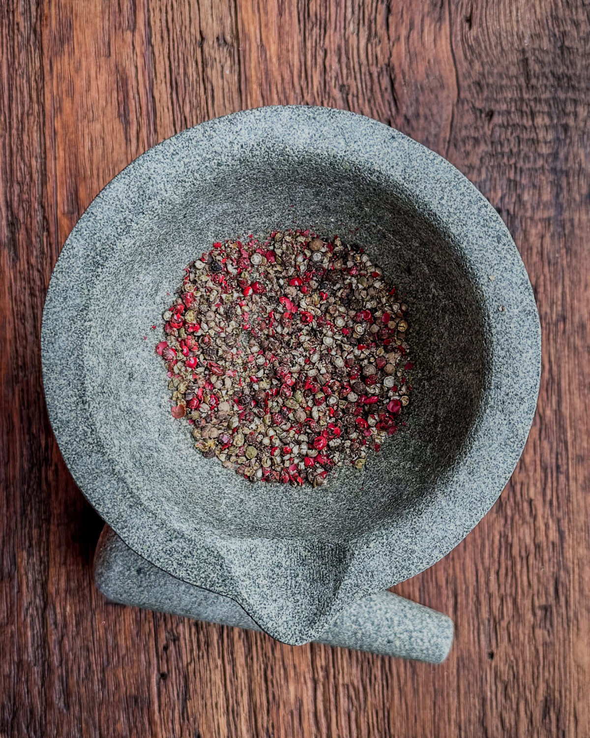 Crush the peppercorns in a mortar and pestle.