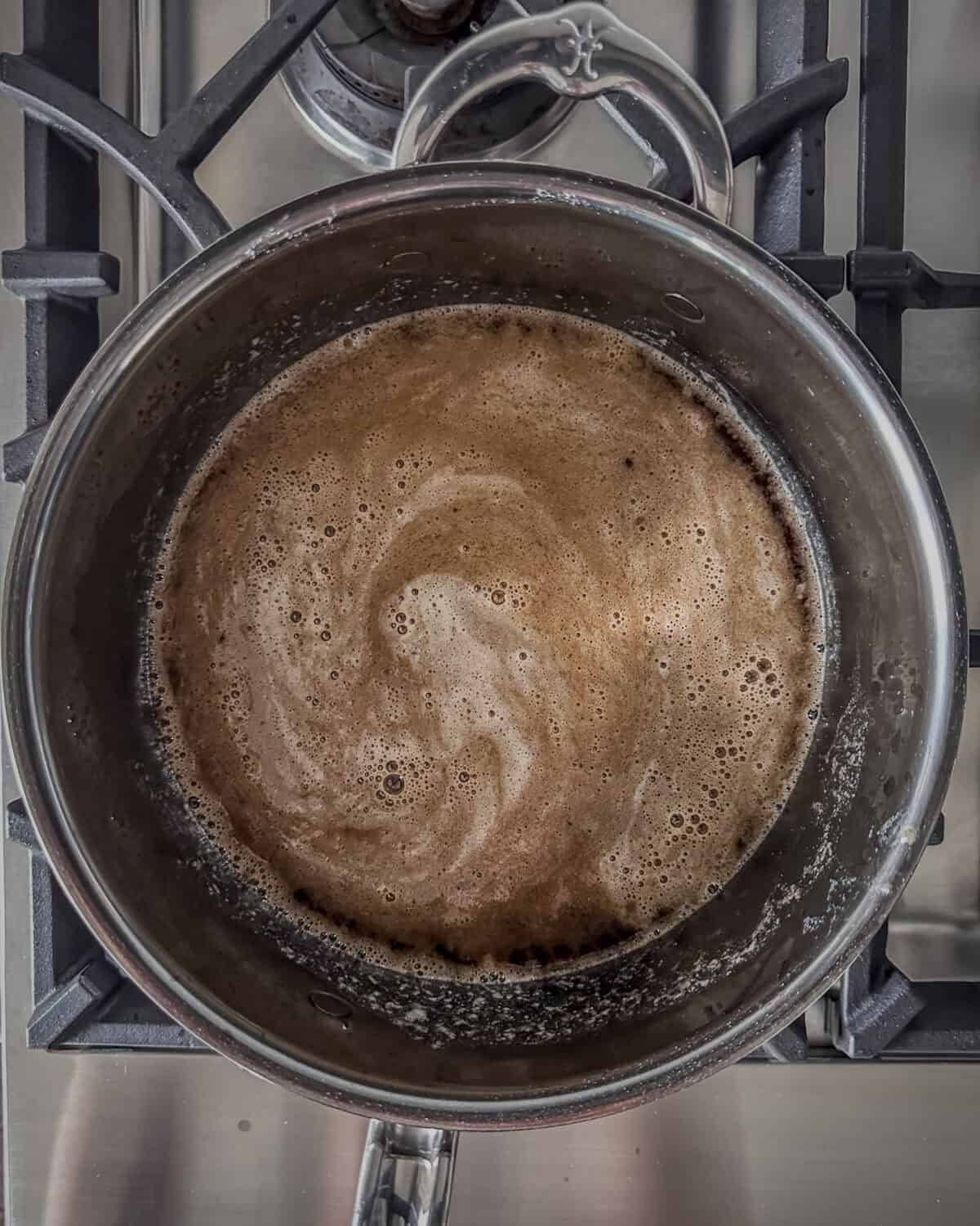 Pour in the beef stock, bring the mixture to a boil, then reduce the heat to a simmer.