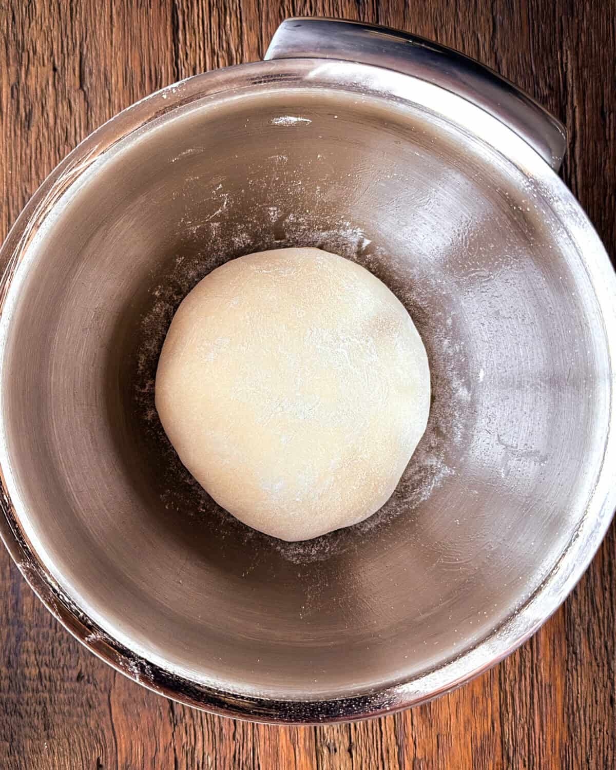 Place the pizza dough ball in a lightly oiled medium mixing bowl to rise.