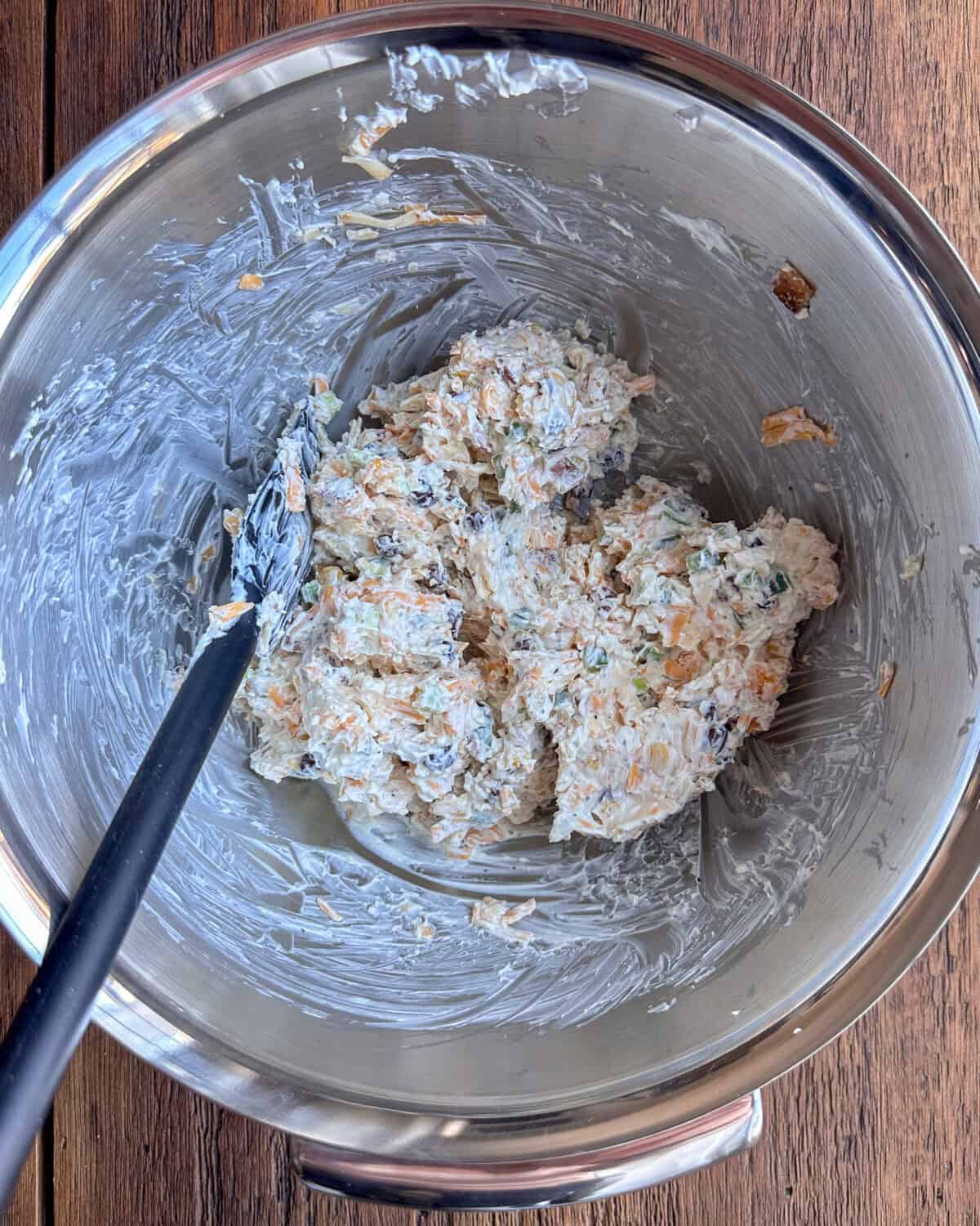 A bowl of cream cheese and jalapeno mixture for a game day dip recipe.