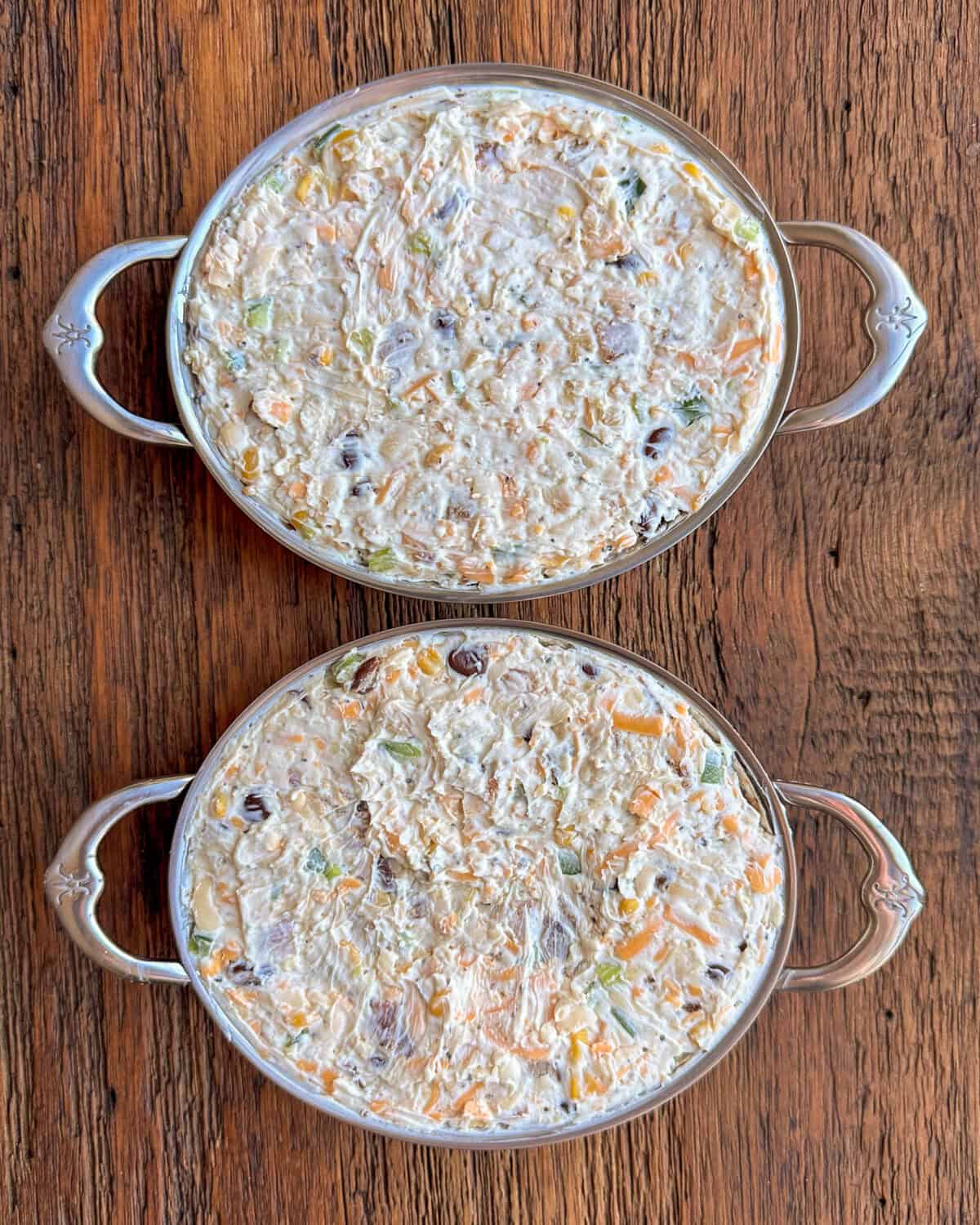 Two au gratin dishes with a cheese dip mixture.