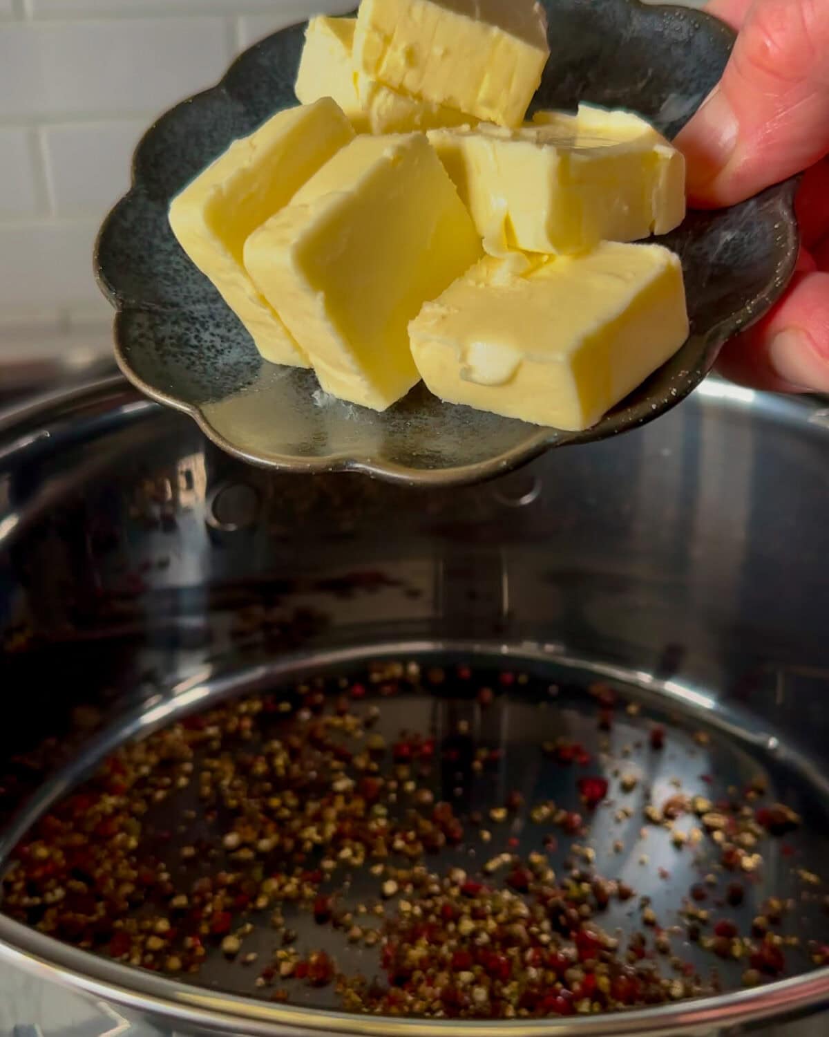 Add the butter to the peppercorns.