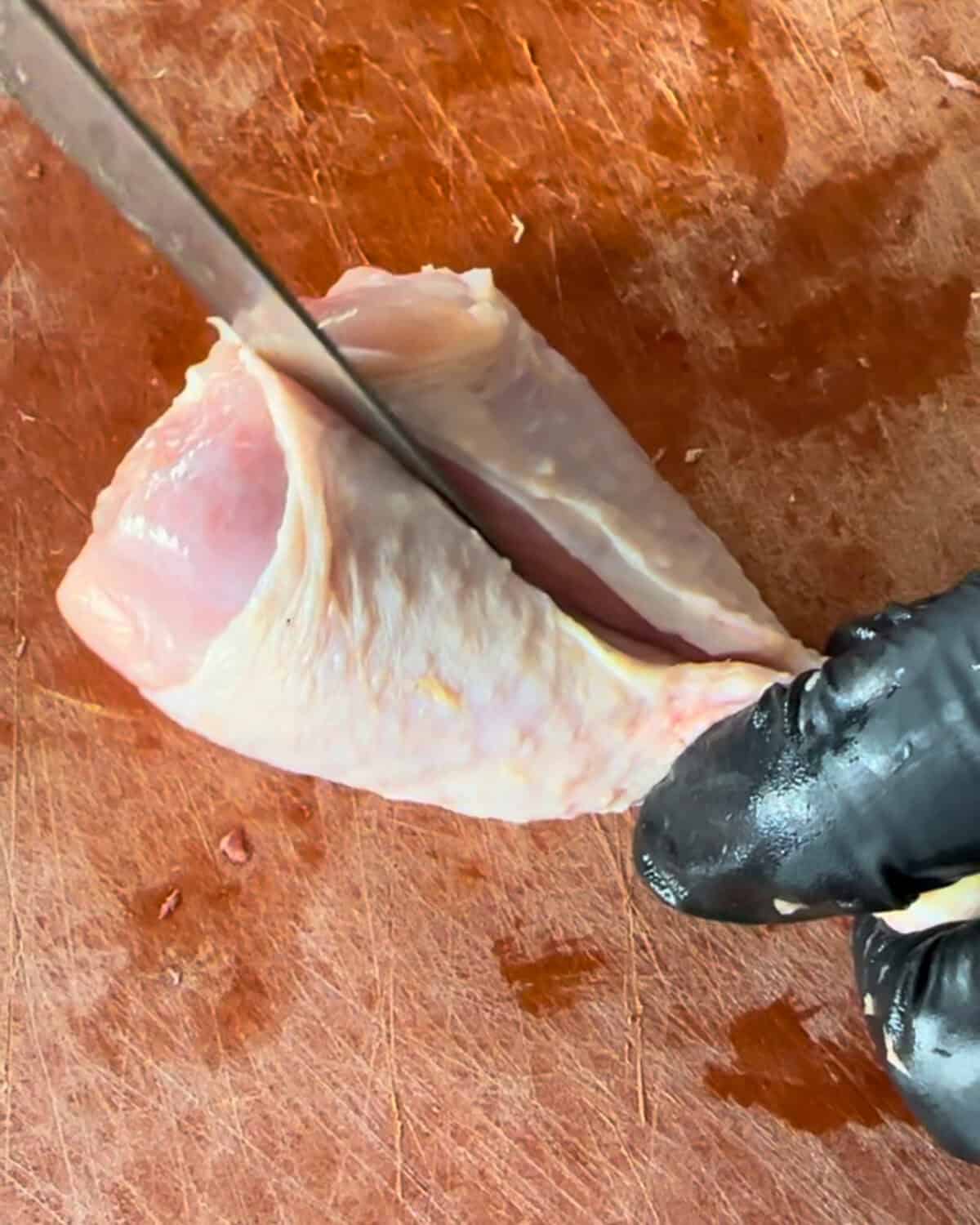 Using a sharp knife, carefully slice lengthwise along the bone-starting from the thinner part and cutting toward the thicker end-without cutting all the way through.