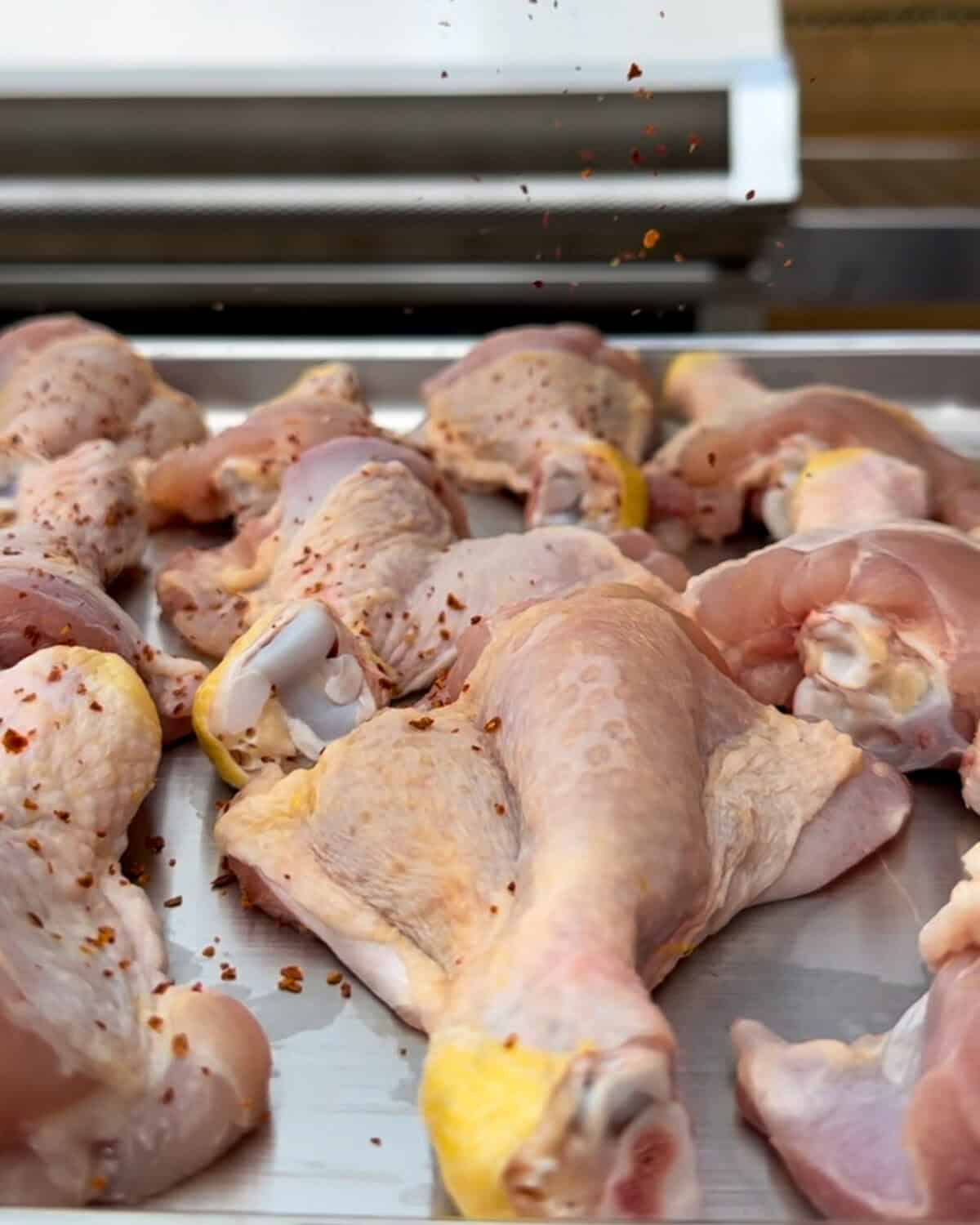Sprinkle Korean red chili pepper flakes on both sides of the butterflied drumsticks.