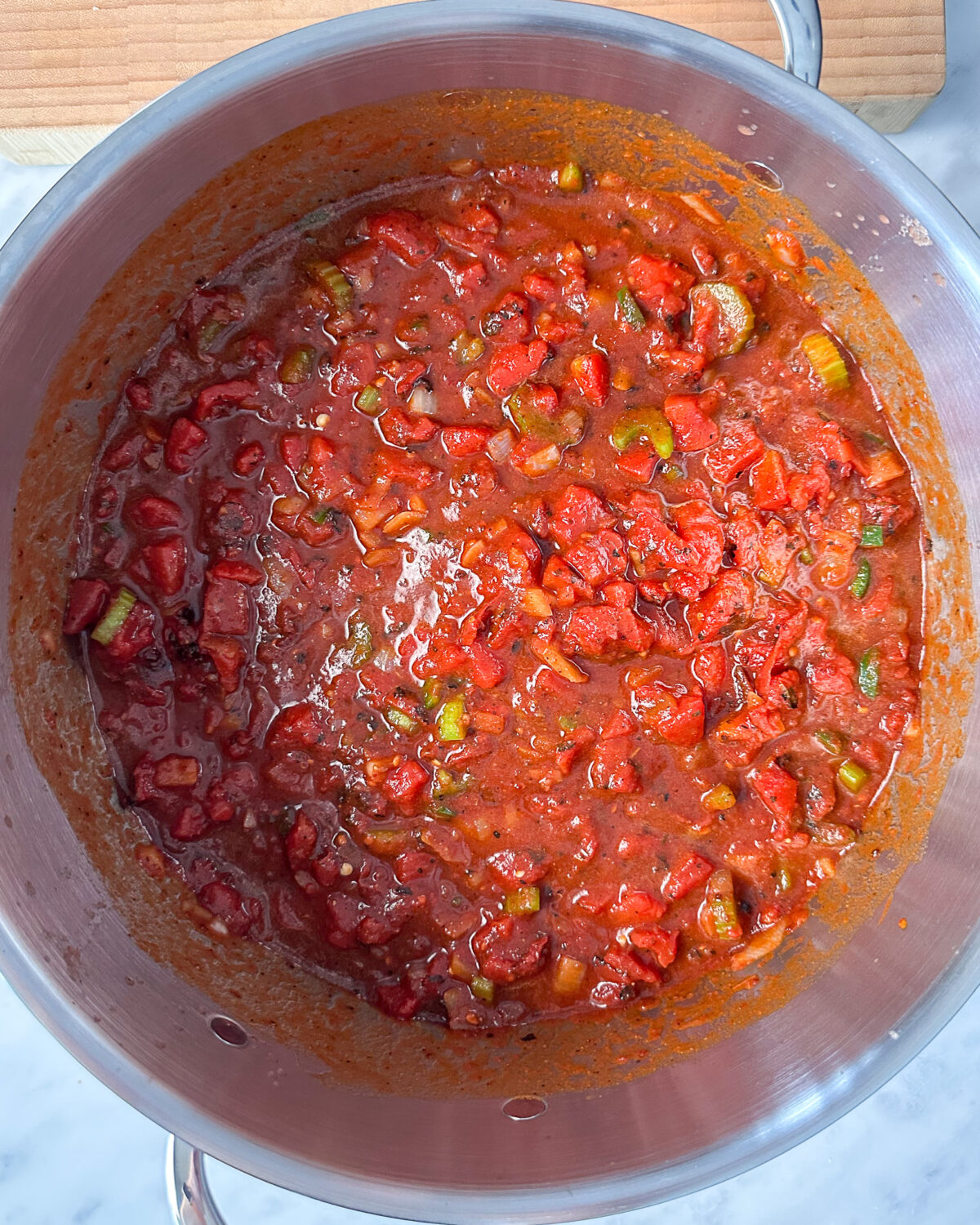 Stir in the low sodium crushed and diced tomatoes into the chili.