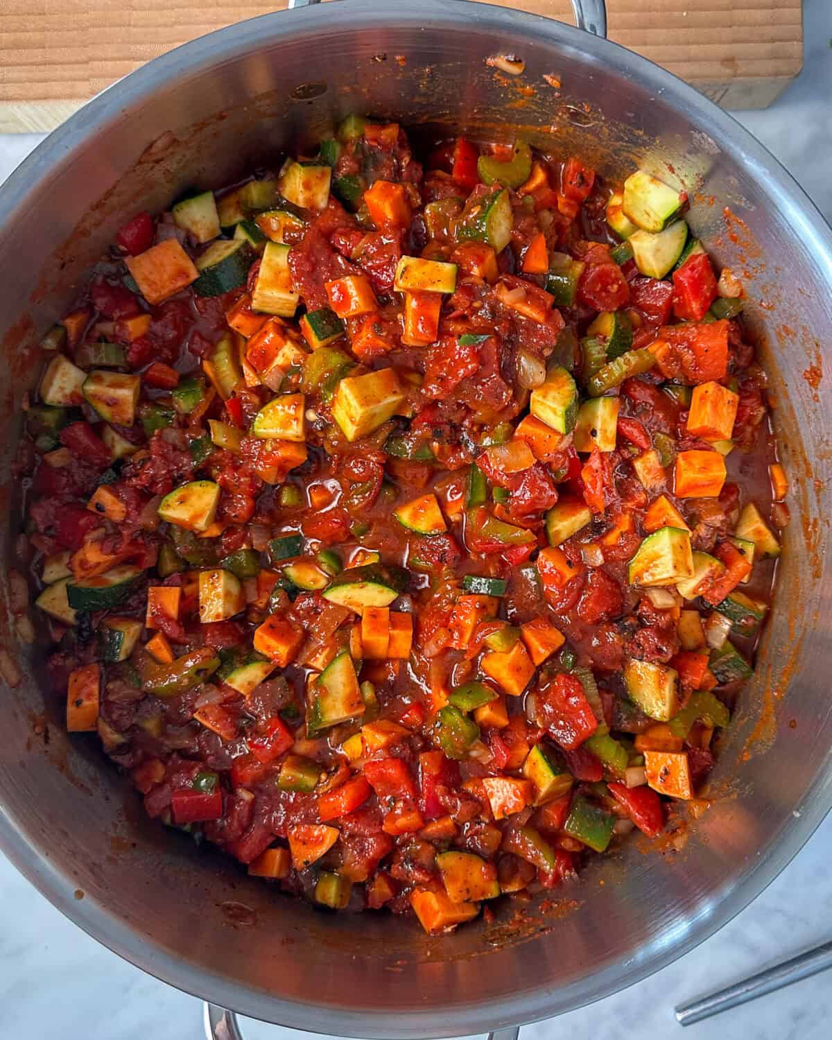 Stir in the sweet potatoes, bell peppers and zucchini into the pot.