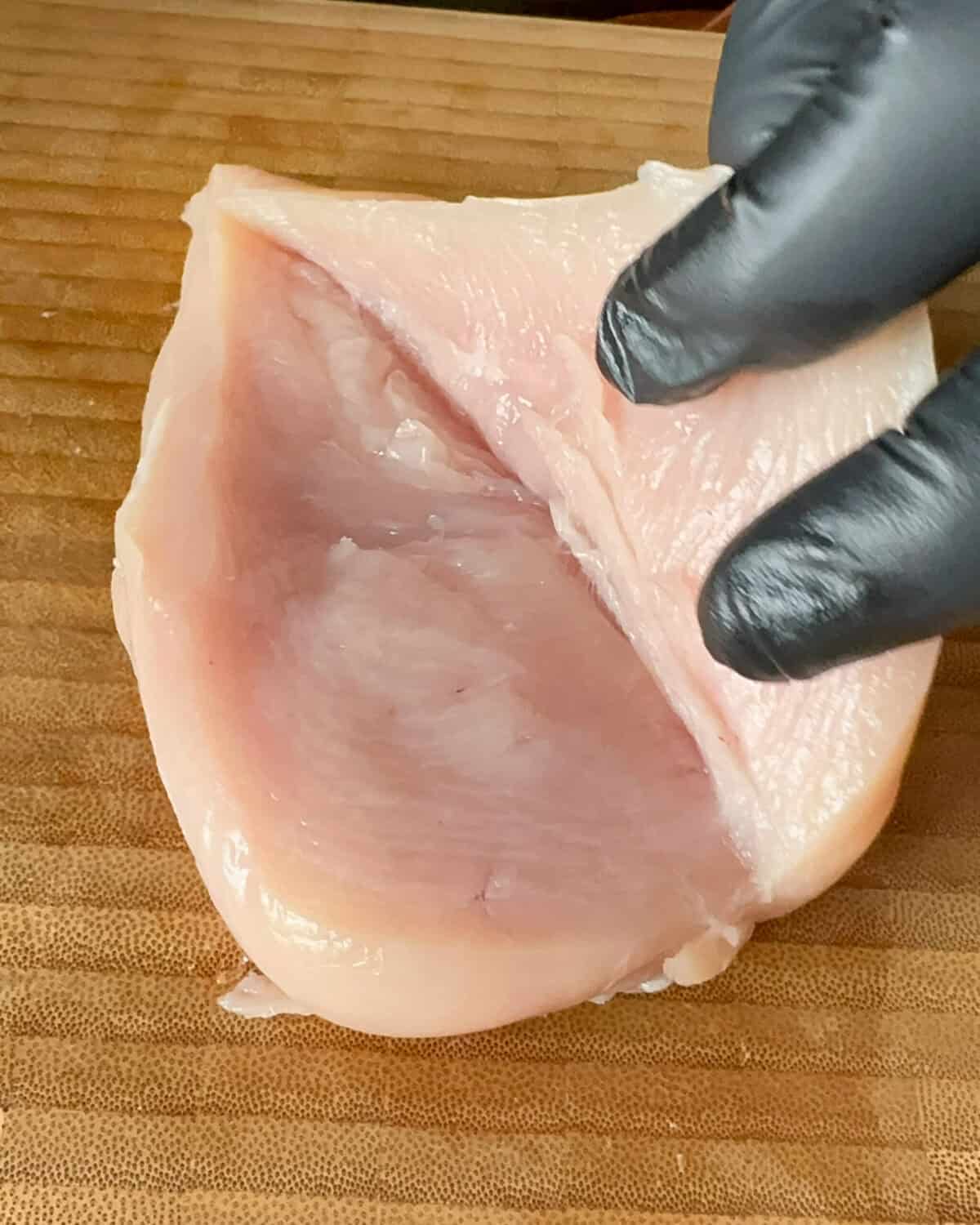A butterflied chicken breast opened up like a book.