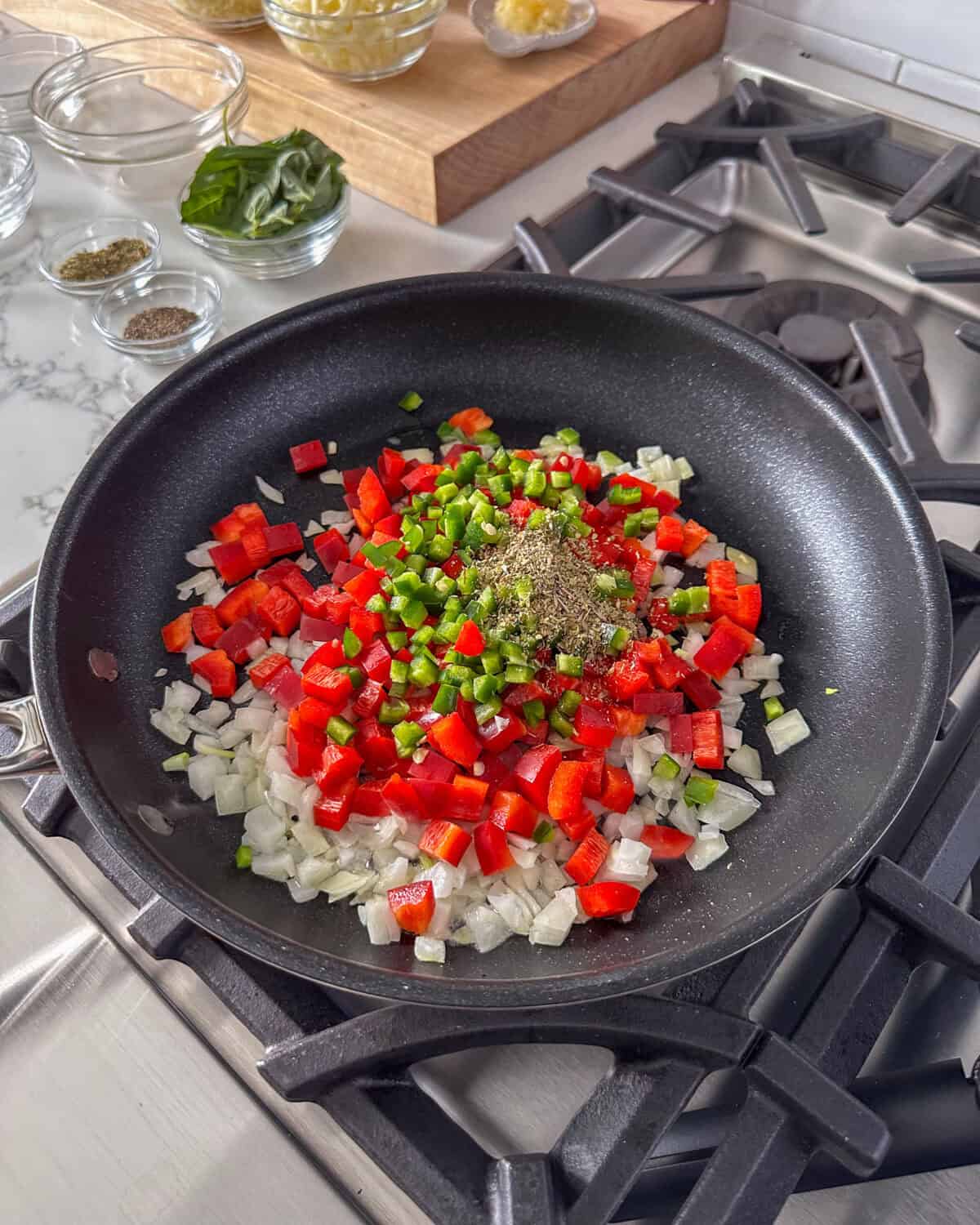 Add the diced onion, red bell pepper, and oregano in a skillet with oil.