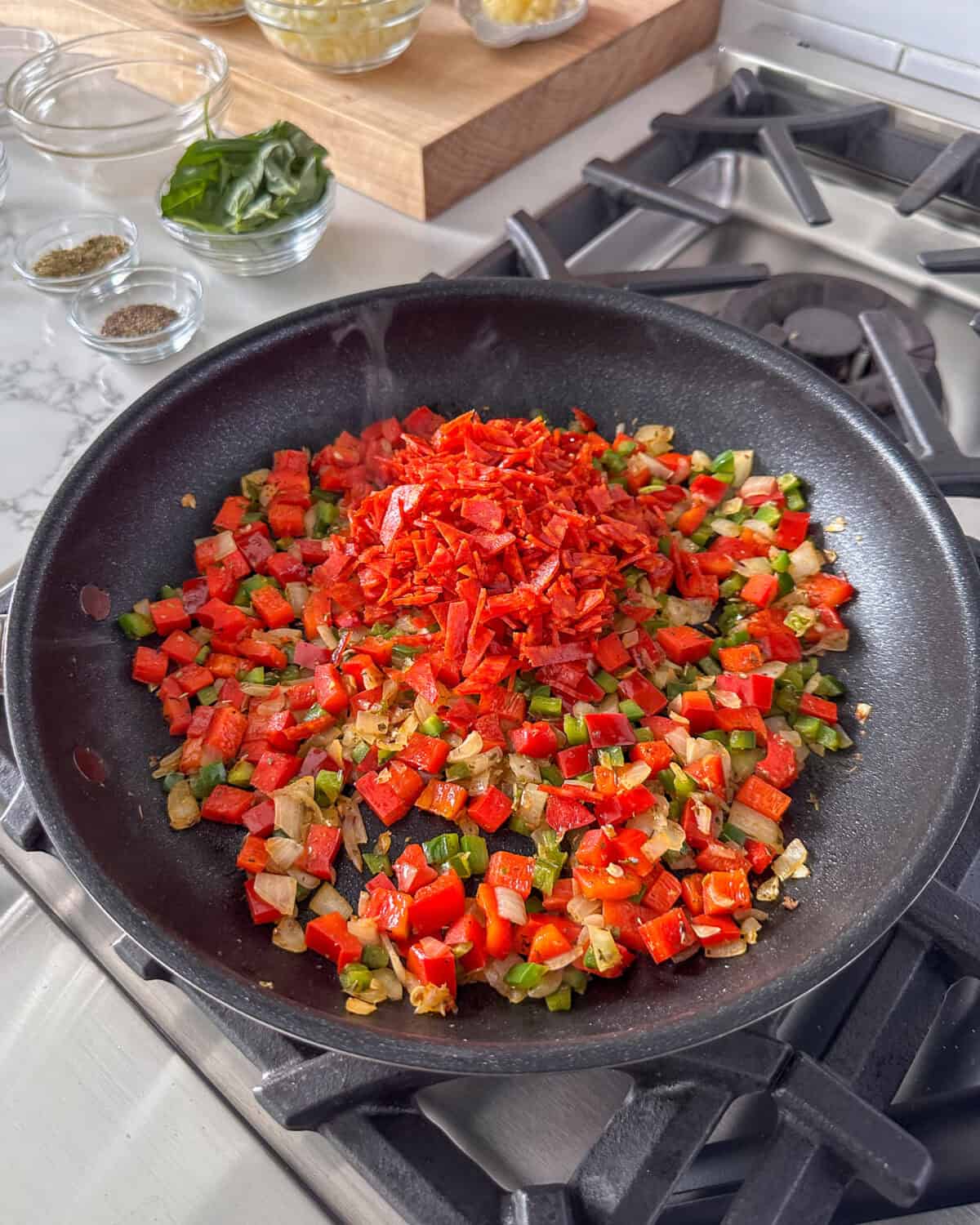 Add the roughly chopped pepperoni into the skillet and cook for 2 minutes.