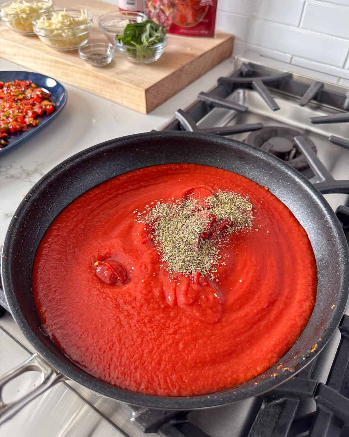 Warm the Passata, tomato paste, and remaining oregano.