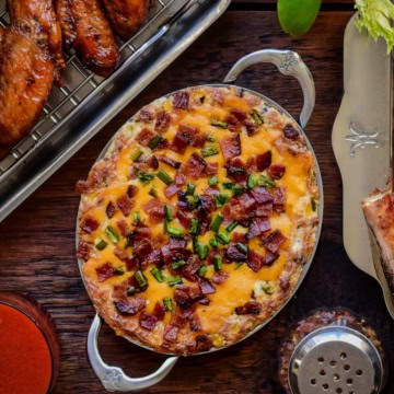 A baked jalapeno popper dip in a small oval au gratin.