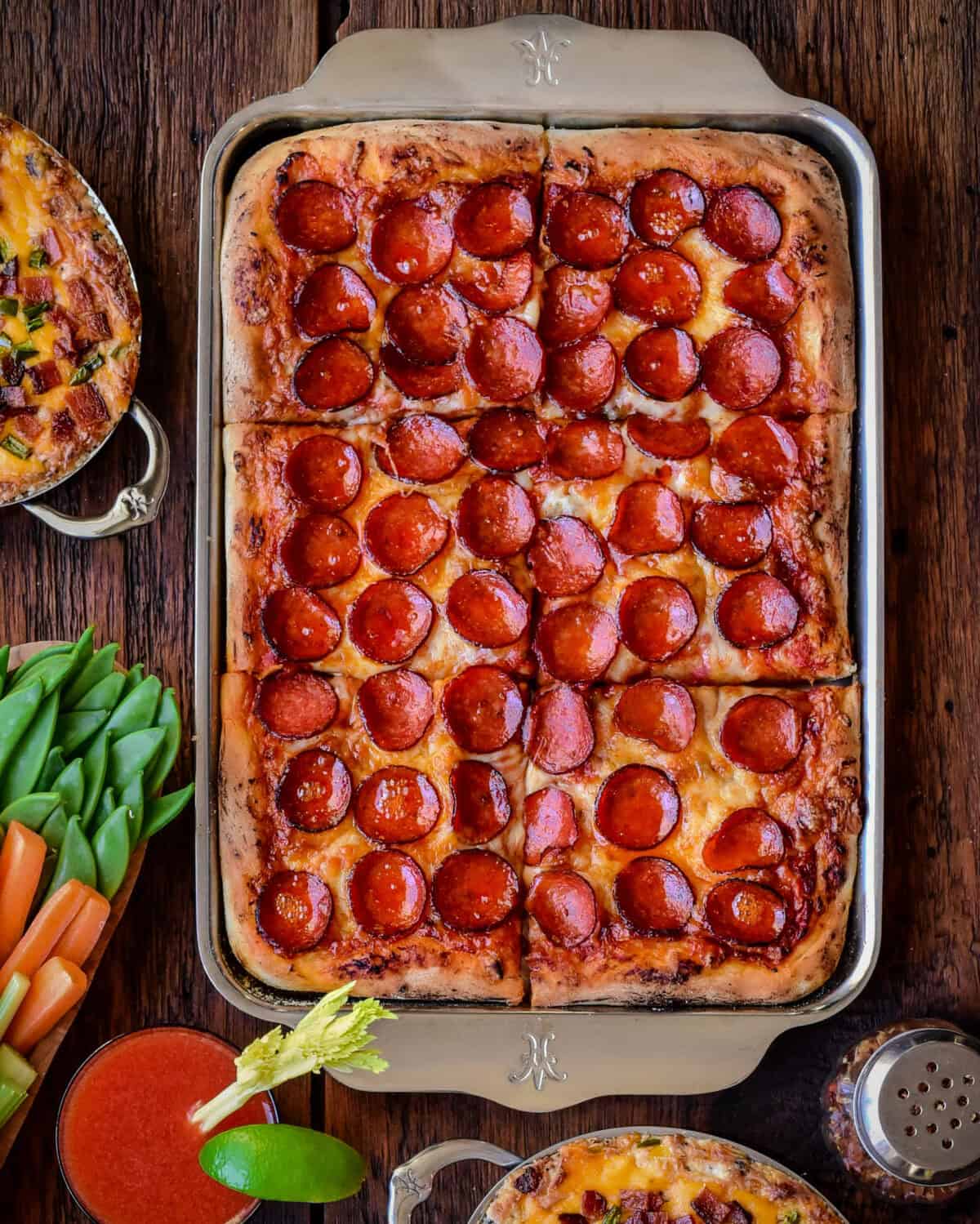 A golden, crispy pepperoni sheet pan pizza with cup and char pepperonis.