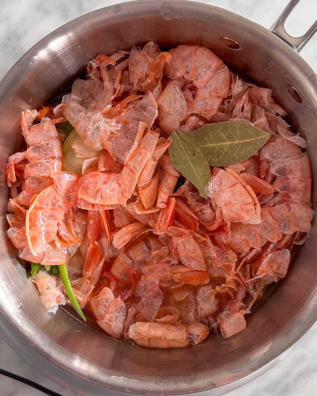 Making shrimp stock with shrimp shells.