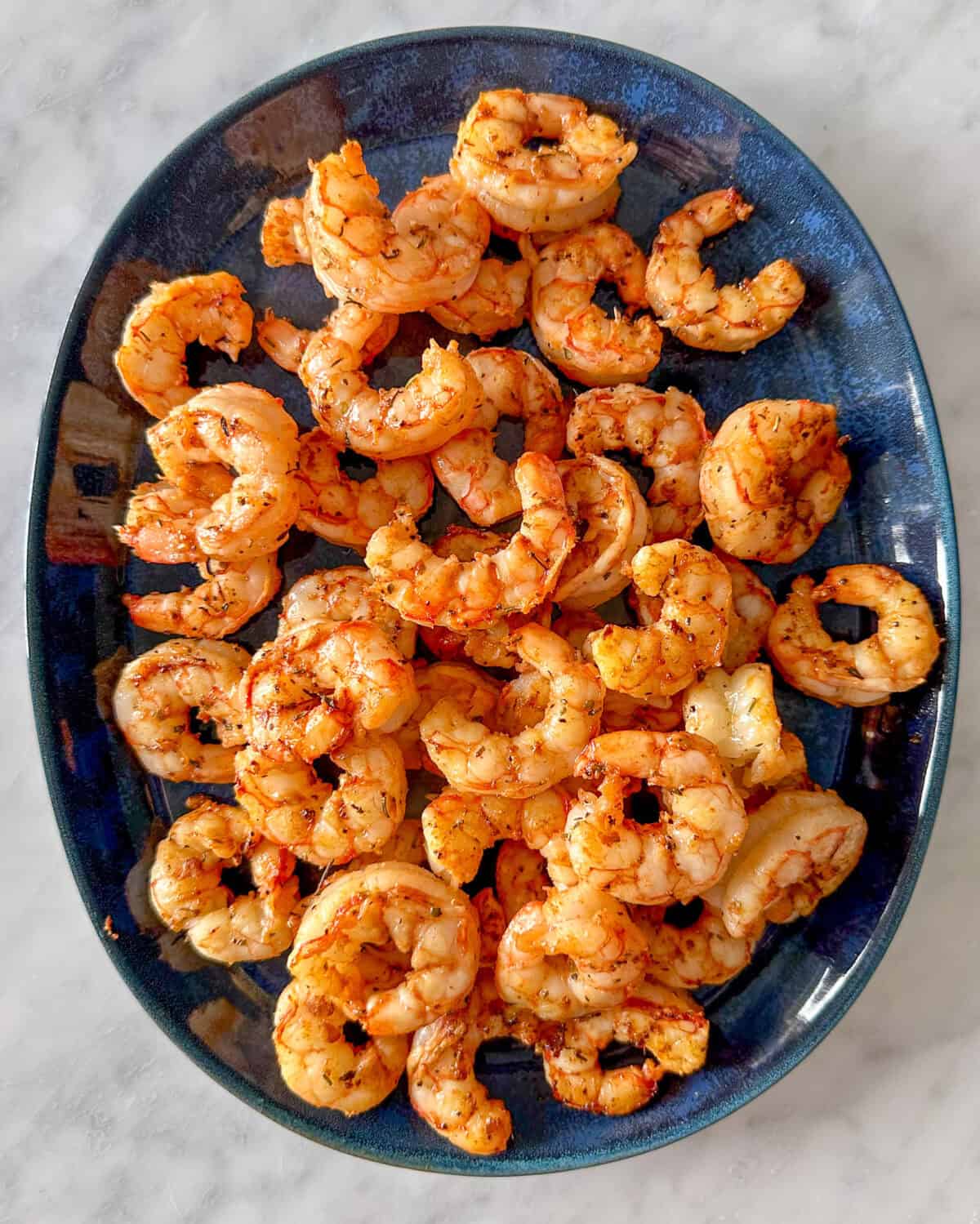 A plate of seared red Argentinian shrimp.