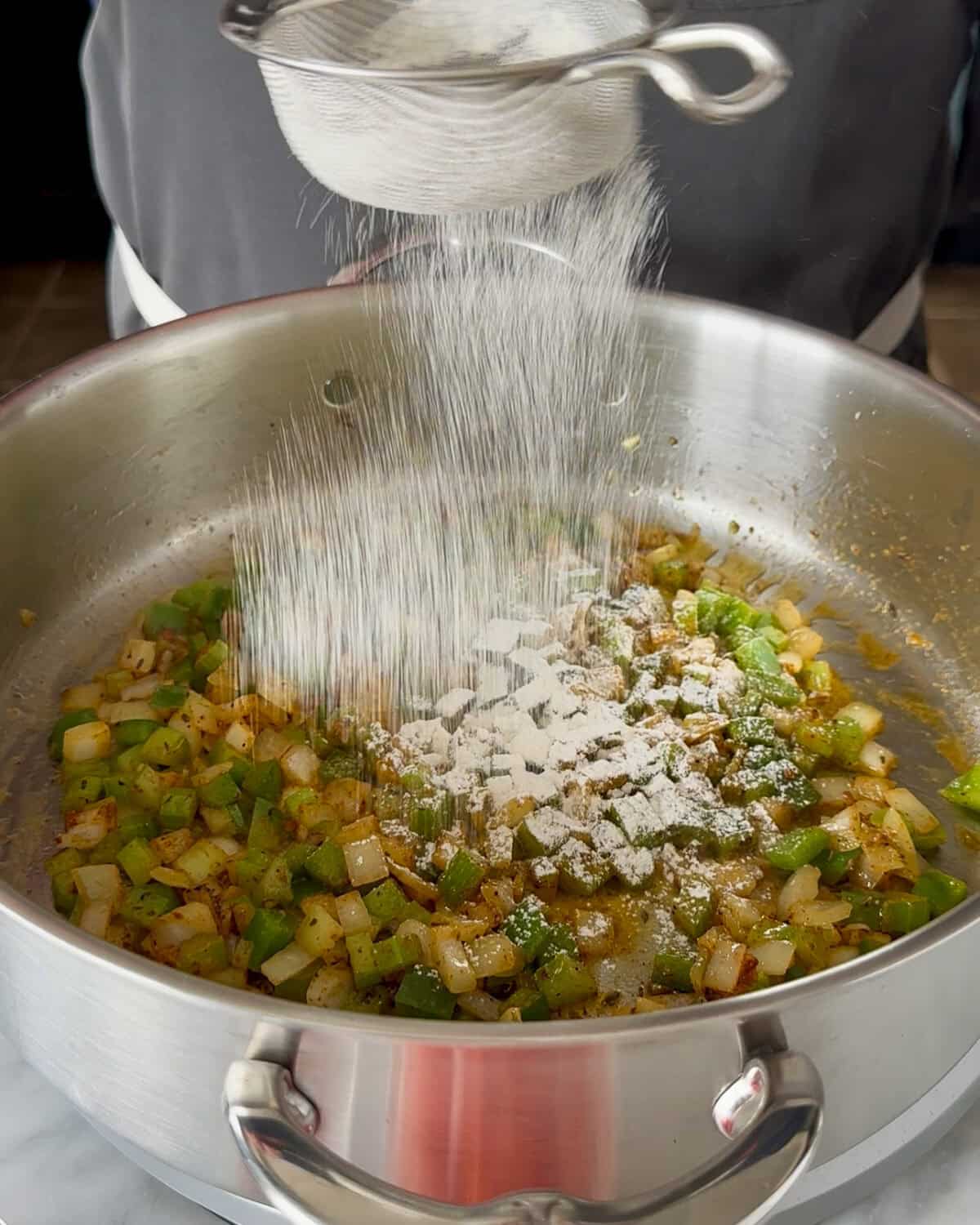 Stir in the remaining spice blend. Then sift or sprinkle in the flour.
