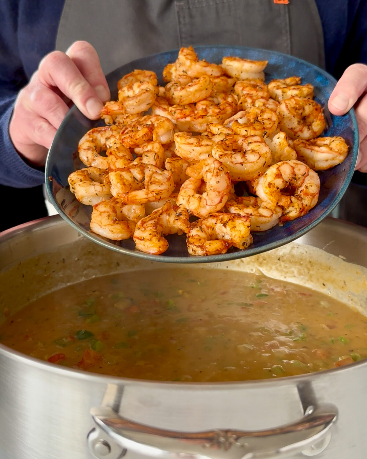 Add the shrimp into the Shrimp Étouffée sauce to simmer.