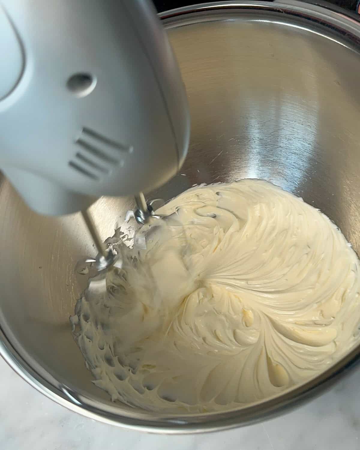 Beat the mascarpone cheese until smooth using a hand or stand blender.