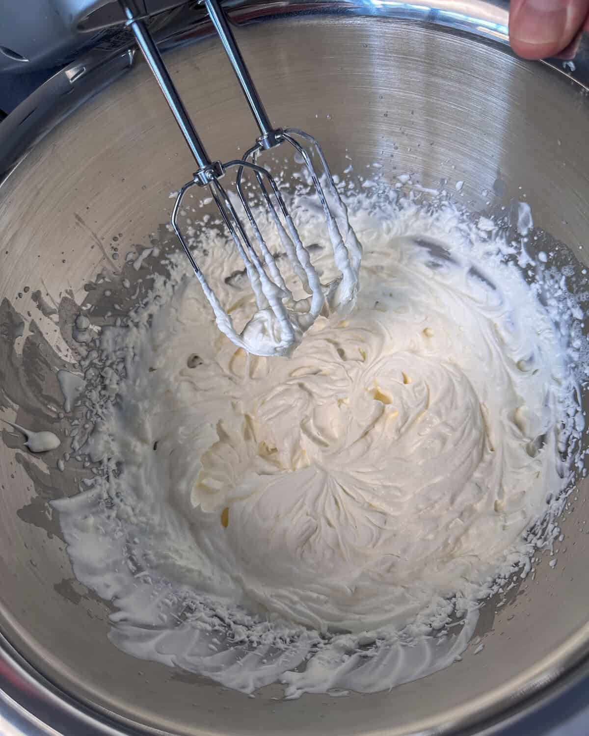 whip the heavy cream and powdered sugar at high speed until stiff peaks form.
