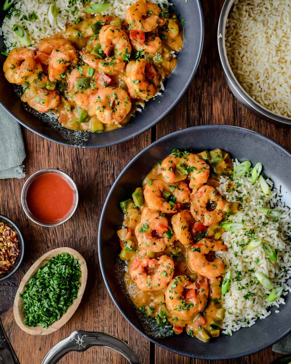 Two bowls of Shrimp Étouffée served with rice.