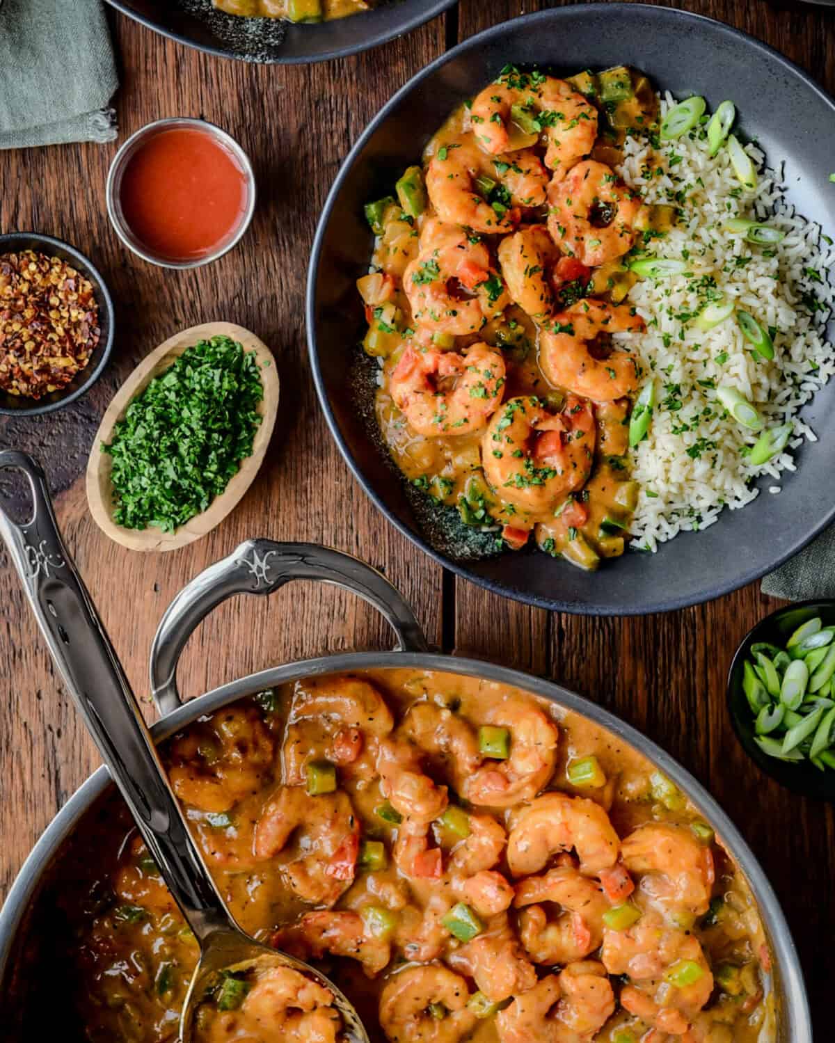 A pot of shrimp Étouffée and a bowl served with rice.