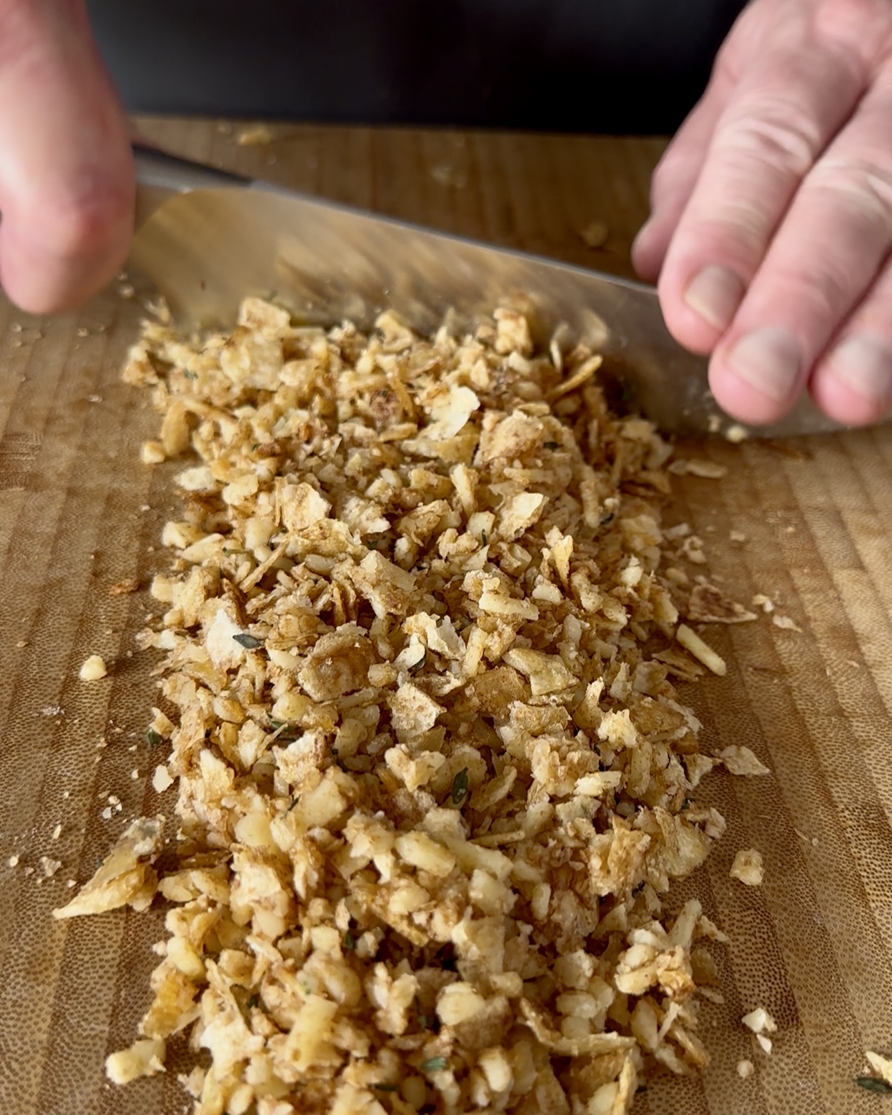 Chop up the chip, cheese and herb topping for the three cheese mac and cheese.