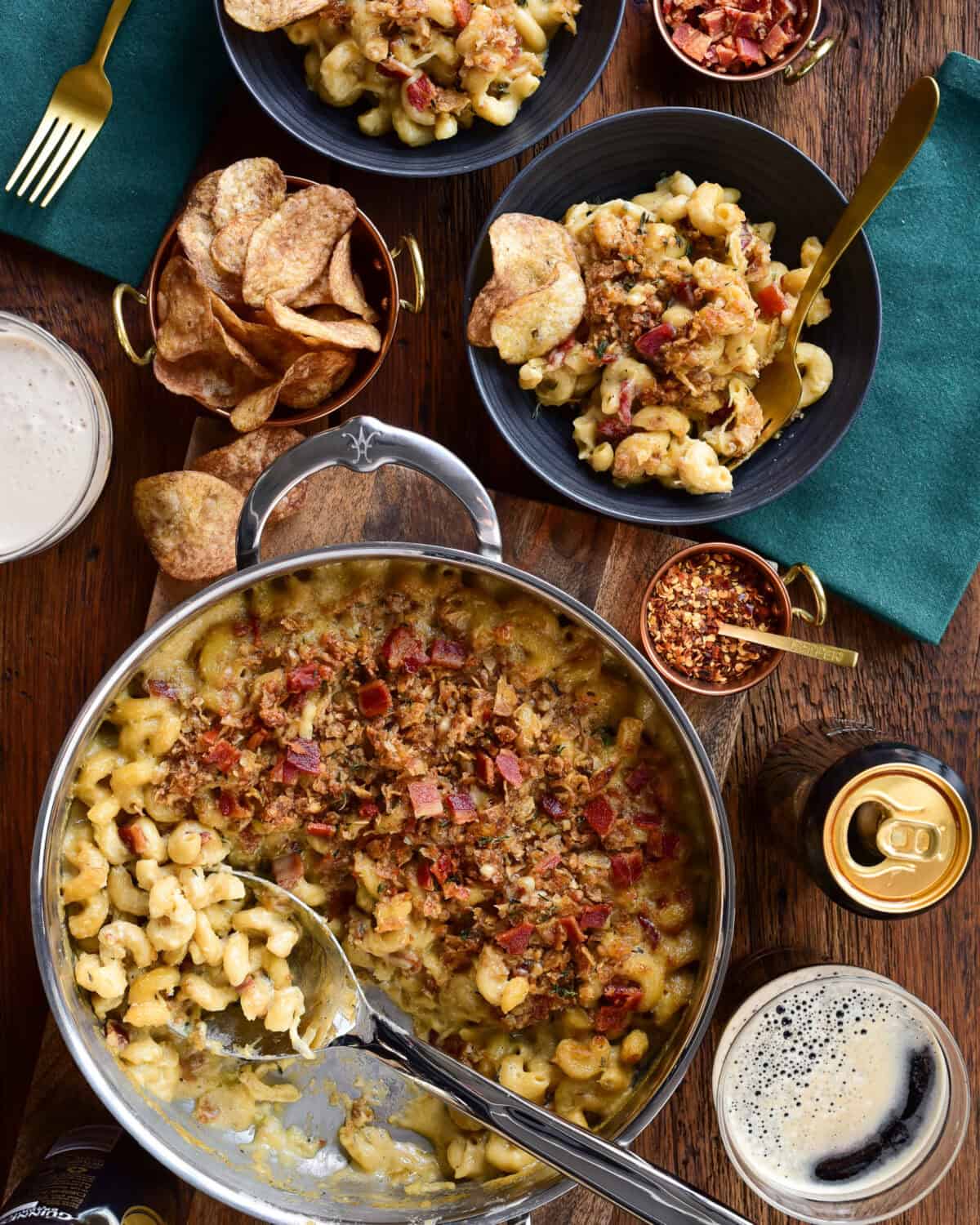 Guinness Mac and Cheese served out of a pan into bowls and served with chips an Guinness.