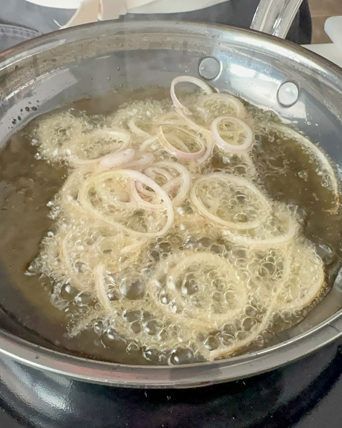 Fry shallots into the hot oil in batches until golden and crispy