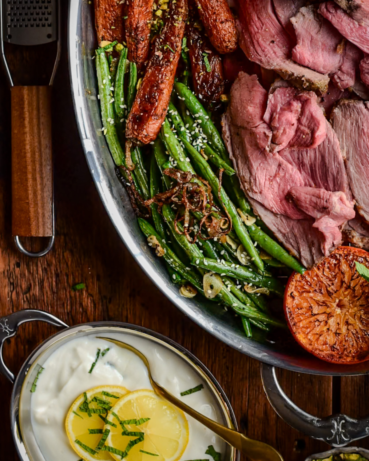 A platter with blistered green beans with lamb.