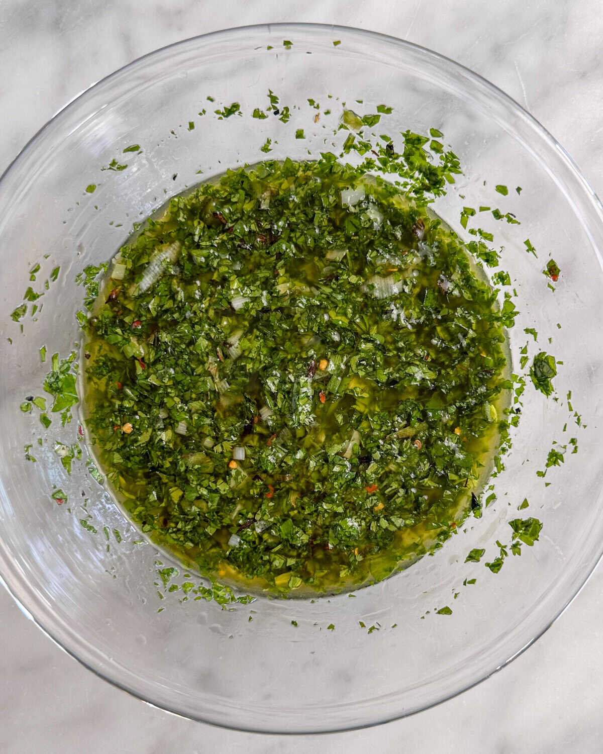 A bowl of Charred Scallion Chimichurri.