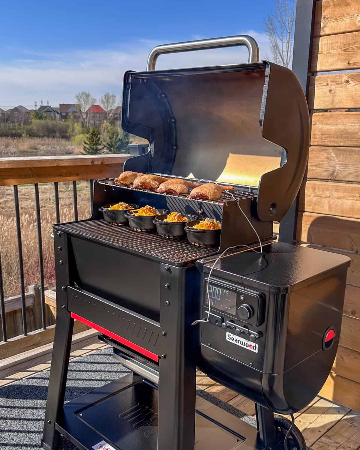 A Weber Searwood 600 with smoked duck legs and mac & cheese.