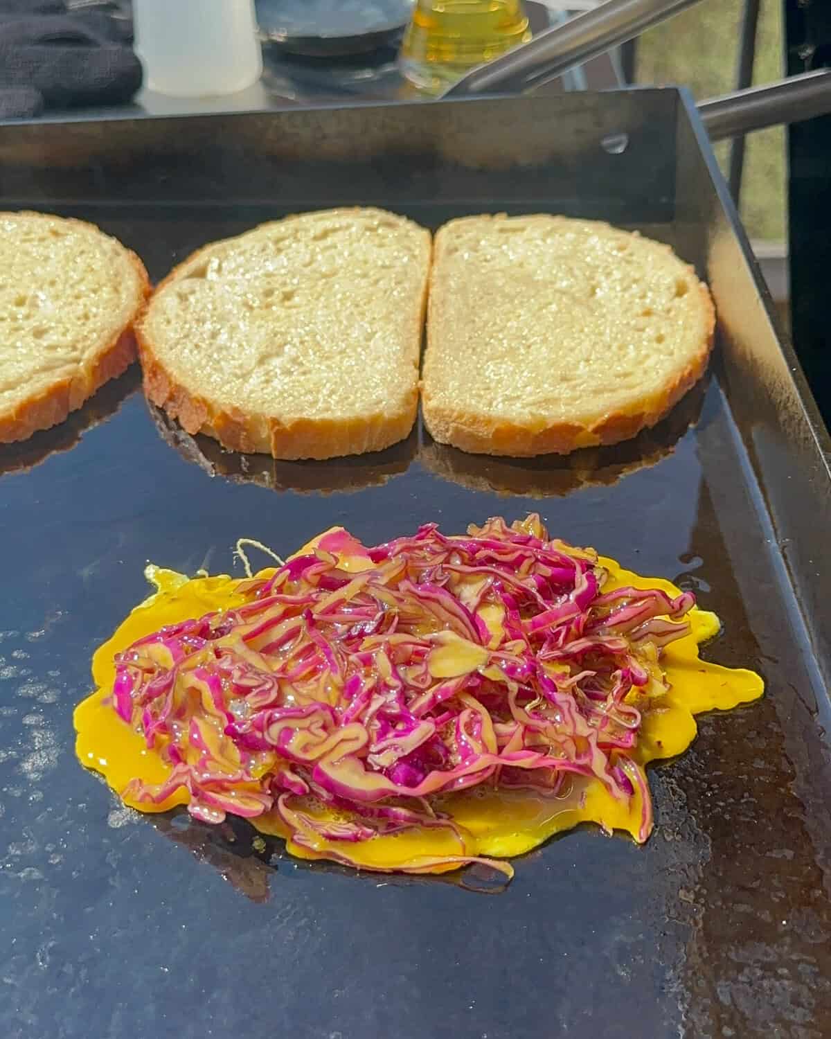 Pour the egg and cabbage mixture on the griddle for the Korean Street Toast Recipe.