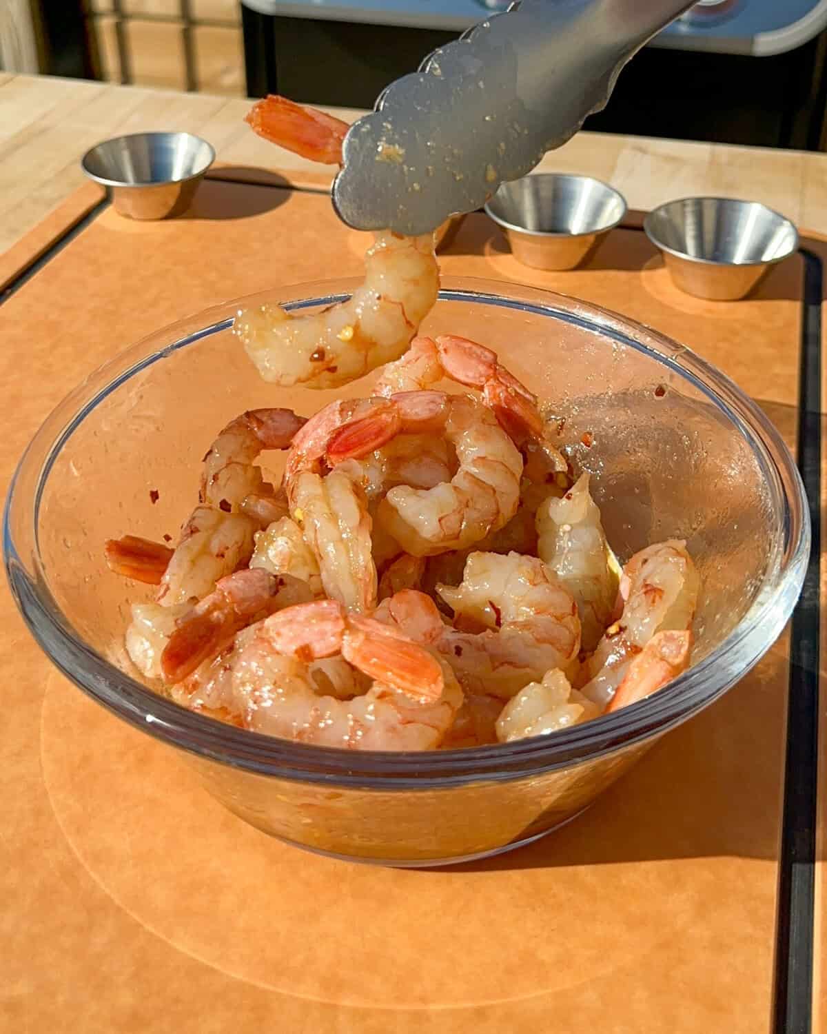 A bowl of marinated shrimp for the griddle.