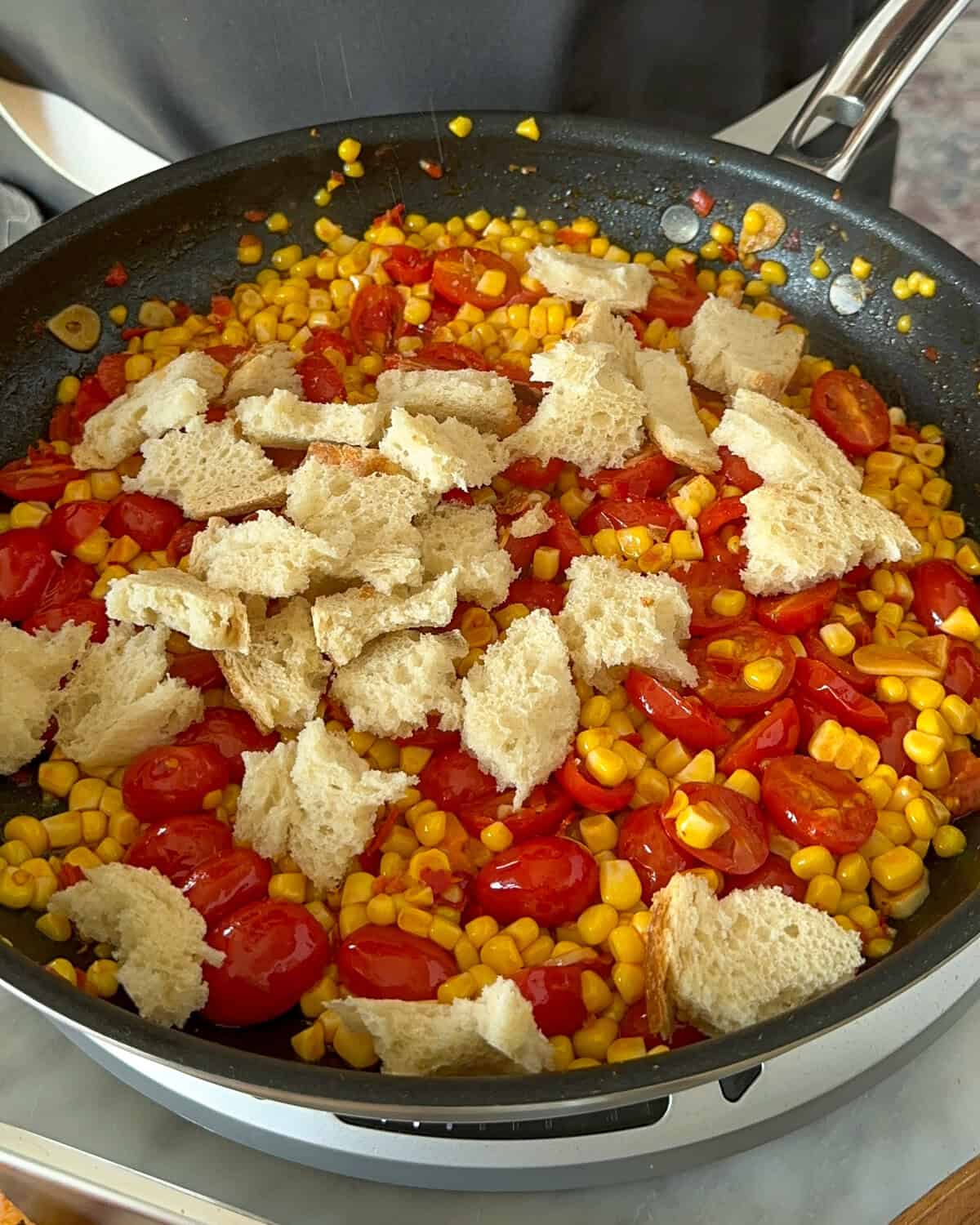 Add torn sourdough directly to the skillet and toss to coat in the spicy tomato juices.