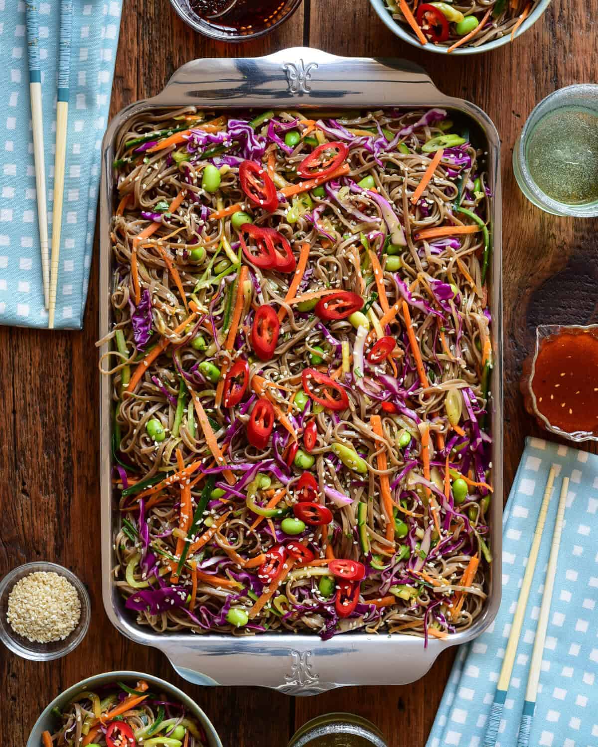 A cold soba noodle salad with sesame ginger dressing served in a quarter sheet pan.