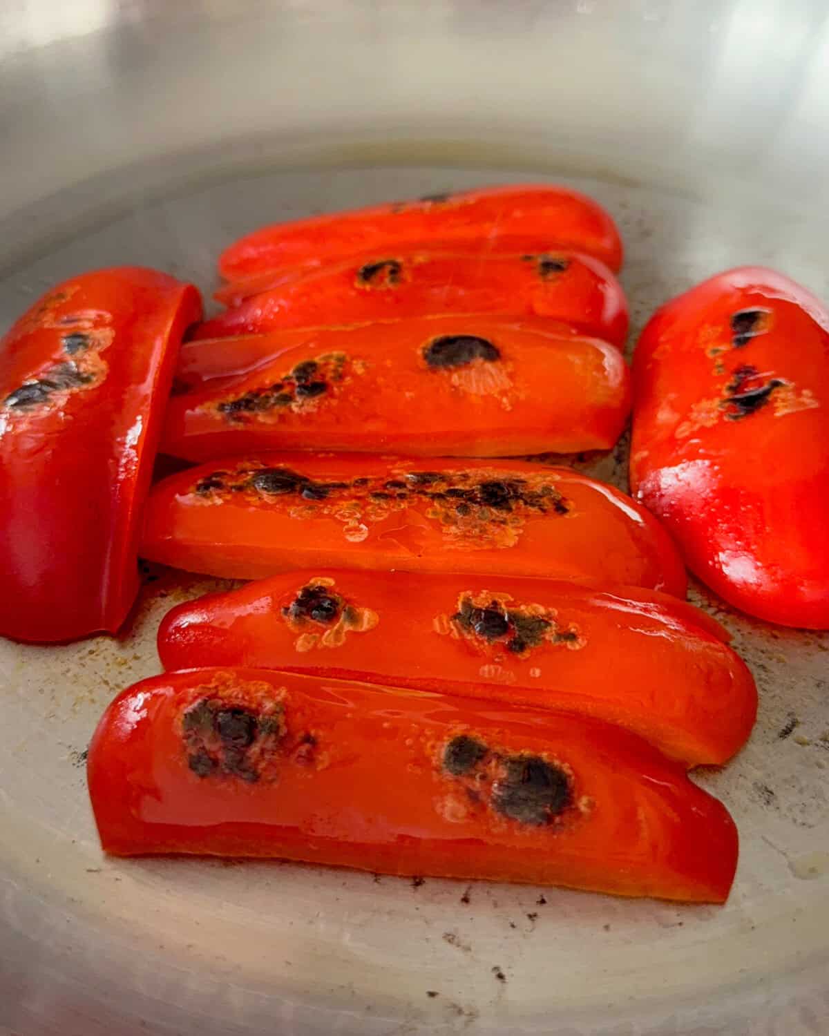 Blistered red pepper pieces for a warm salad.